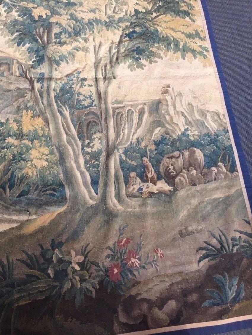 Authentic Aubusson Tapestry.
Pastoral scene per Jean Baptiste Huet.
Depicting a shepherd boy and young girl seated with sheep and a water fall.

Wool and silk.

Lined and dry cleaned per a professional tapestry restorer.
     