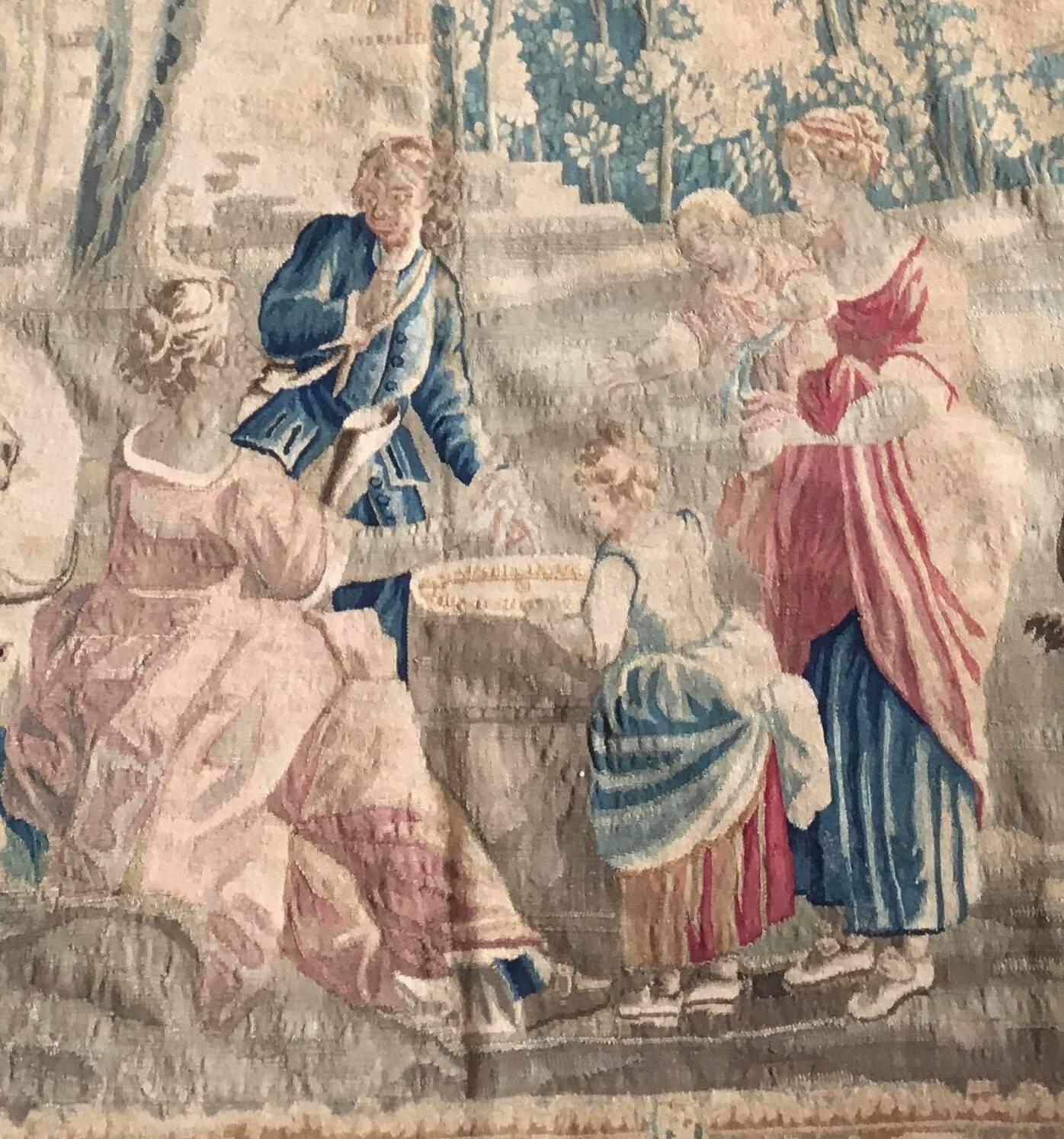 Authentic Aubusson Tapestry.
Fortune Teller scene near a river flanked by grazing cows, against a background of woods with an arcade bridge and ruins and with further buildings in the distance.
 Within a gilded frame border, 

Great
