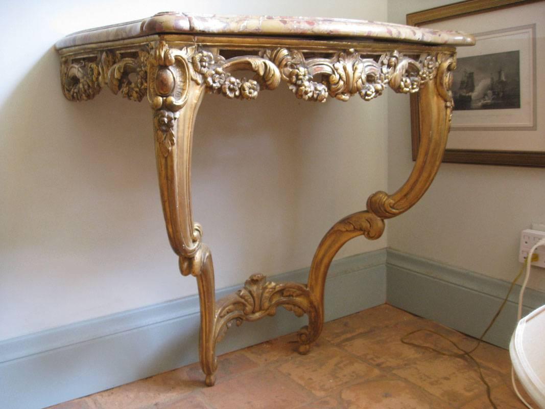 Carved giltwood console.
Original top made of Breche d'Alep.
Two legs with a single entretoise.
Wall-mounted,

French, 18th century period.