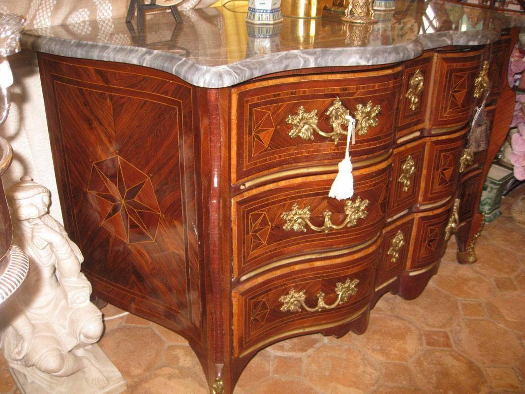 Description:

Rare drawer chest,
Louis XV period,
early 18th century.
Arbalete model. 
Ormolu and inlaid.
Original marble top: 