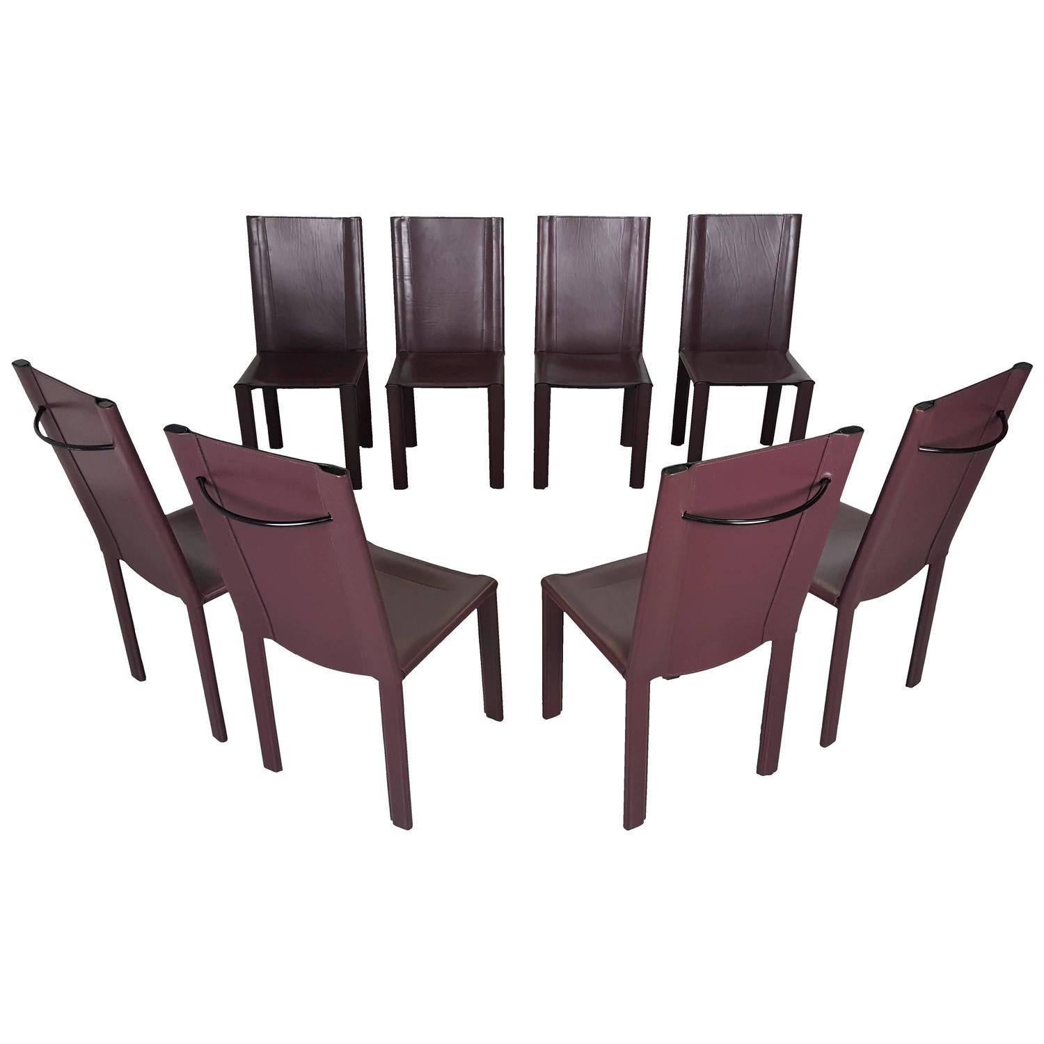 Sophisticated set of eight dining chairs in bordeaux leather by Matteo Grassi, Italy. Incredibly heavy and well constructed; remarkable craftsmanship. Embossed 