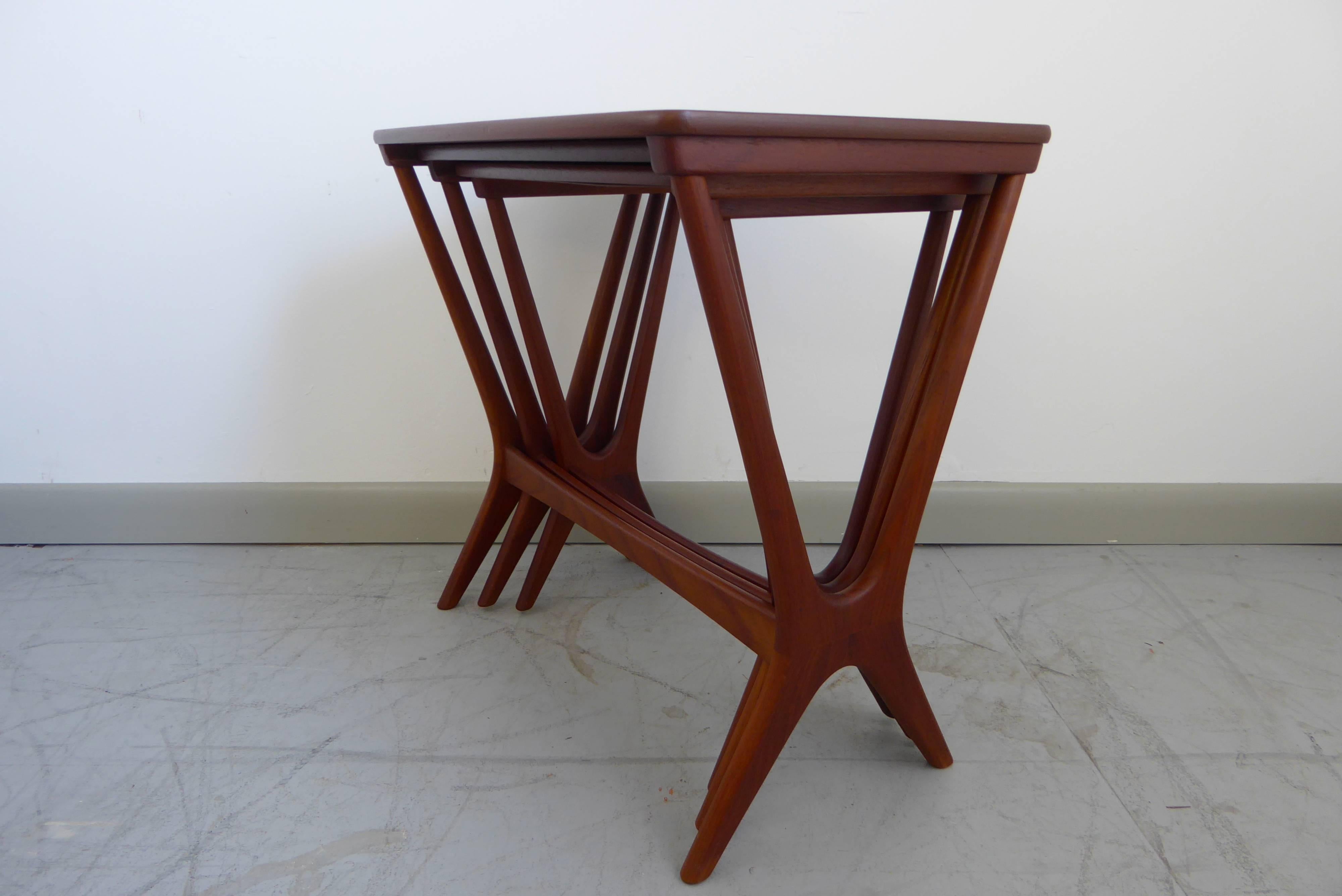 Stunning set of three teak wood nesting tables designed by Erling Torvits and made in Denmark by Heltborg Møbler, 1958. Professionally refinished. Makers mark underneath.

     