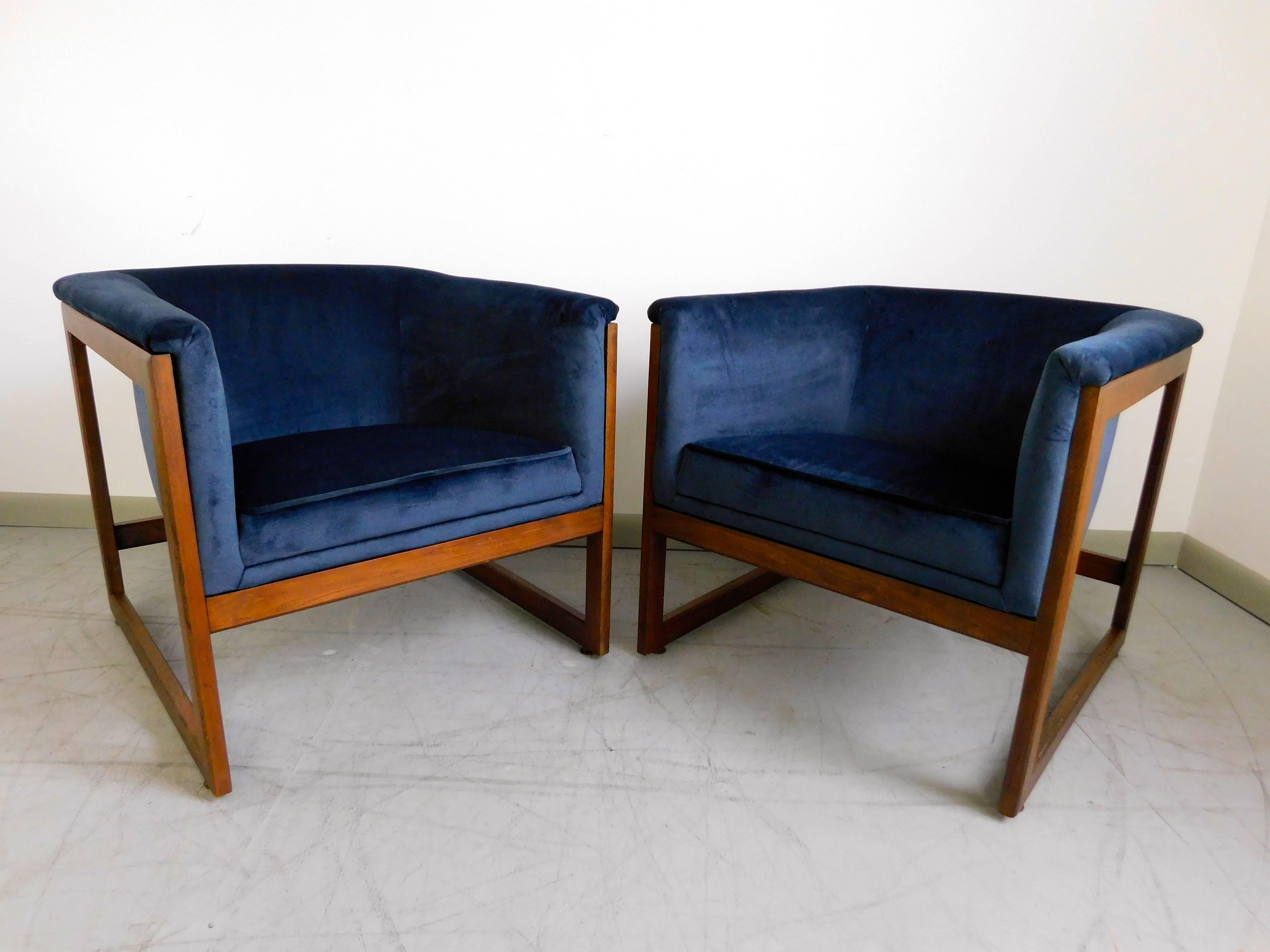 A pair of floating cube chairs by Milo Baughman freshly upholstered in luxurious deep navy blue velvet over newly refinished walnut frames.