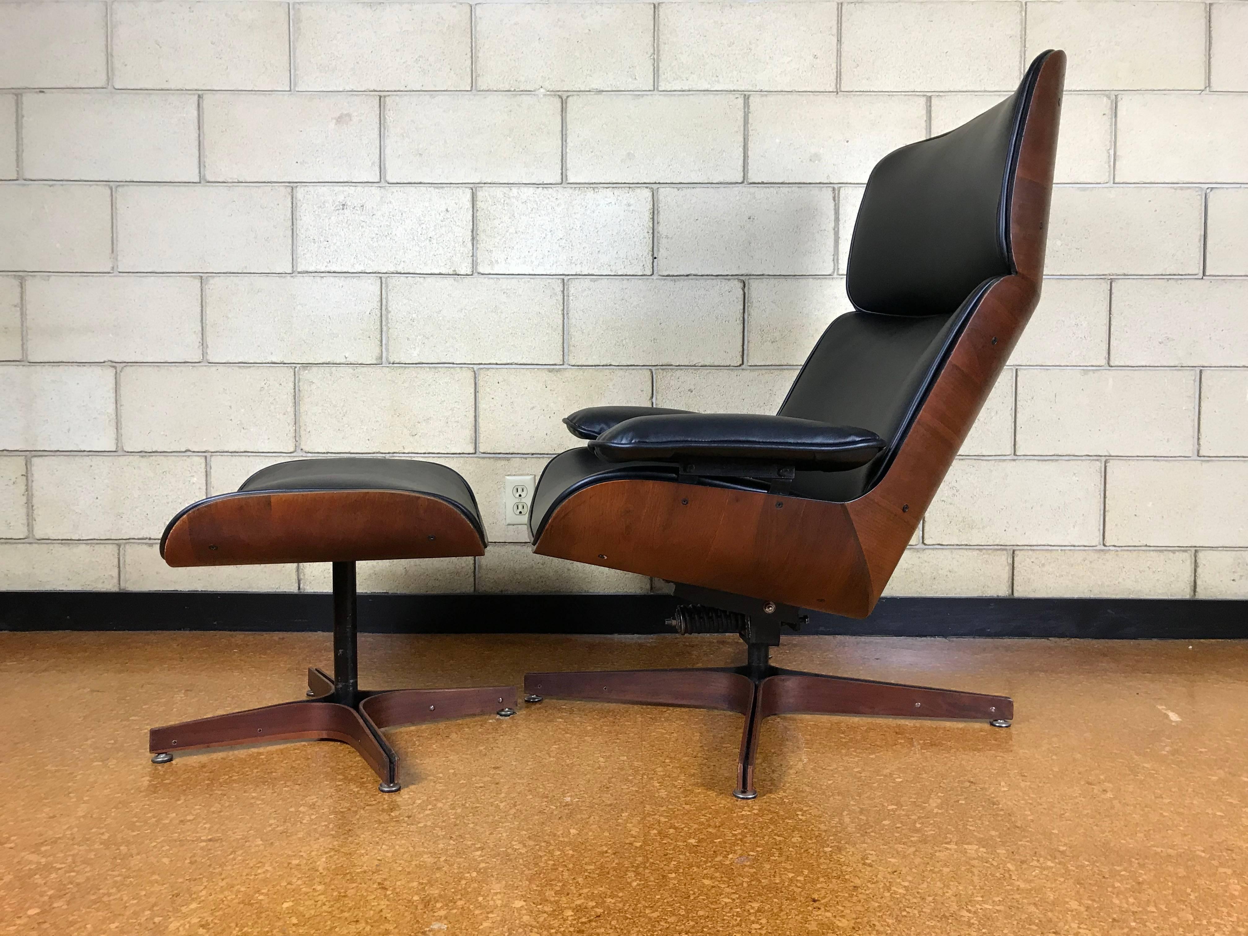 Made of walnut, new cushions and black Naugahyde fabric - this example of Mulhauser's work is sleek and very comfortable. The chair can be adjusted to lean very far back. The walnut back is original. Please see pictures of minor blemishes/marks; it