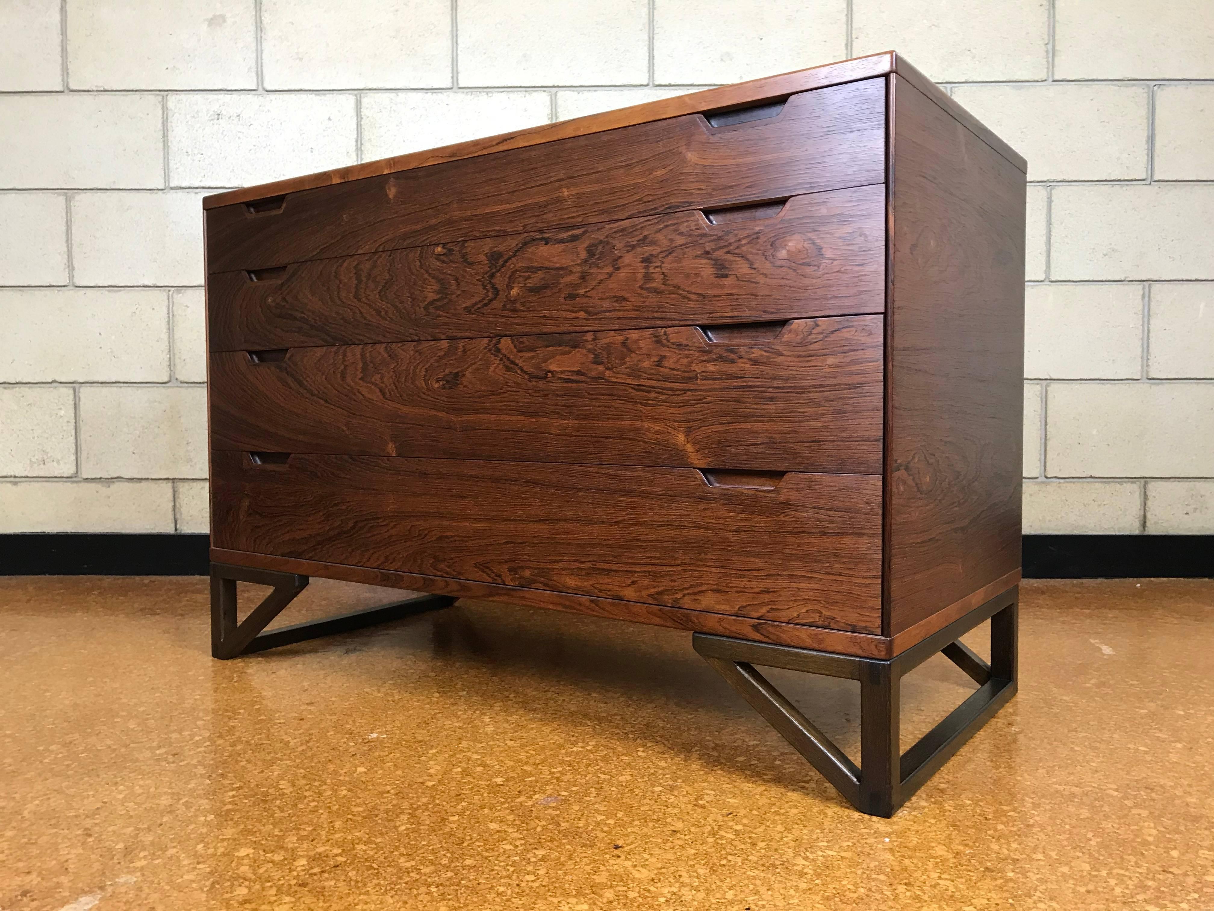 Beautiful and rare Danish Modern chest designed by Svend Langkilde. Made of grain-matched Rosewood - this piece is exceptional because it is in completely original excellent condition. Insides of the drawers are clean and have a faint cedar scent.