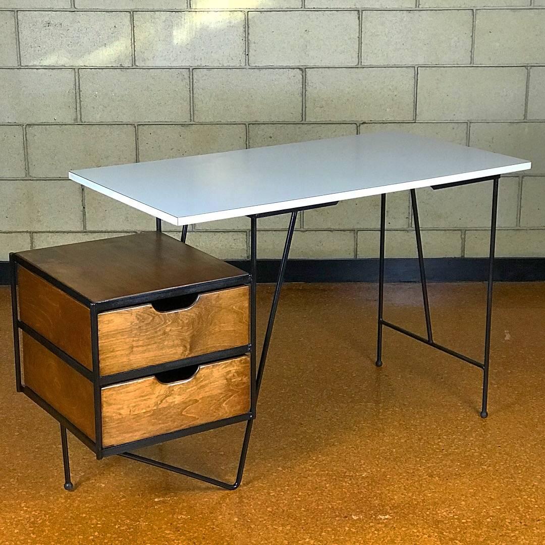 Wonderful use of contrasting materials including iron, wood & white laminate, in this hard-to-find 1950's modernist desk designed by D. R. Bates & Jackson Gregory, Jr. for Vista of California. Restored frame & drawers. The white Formica