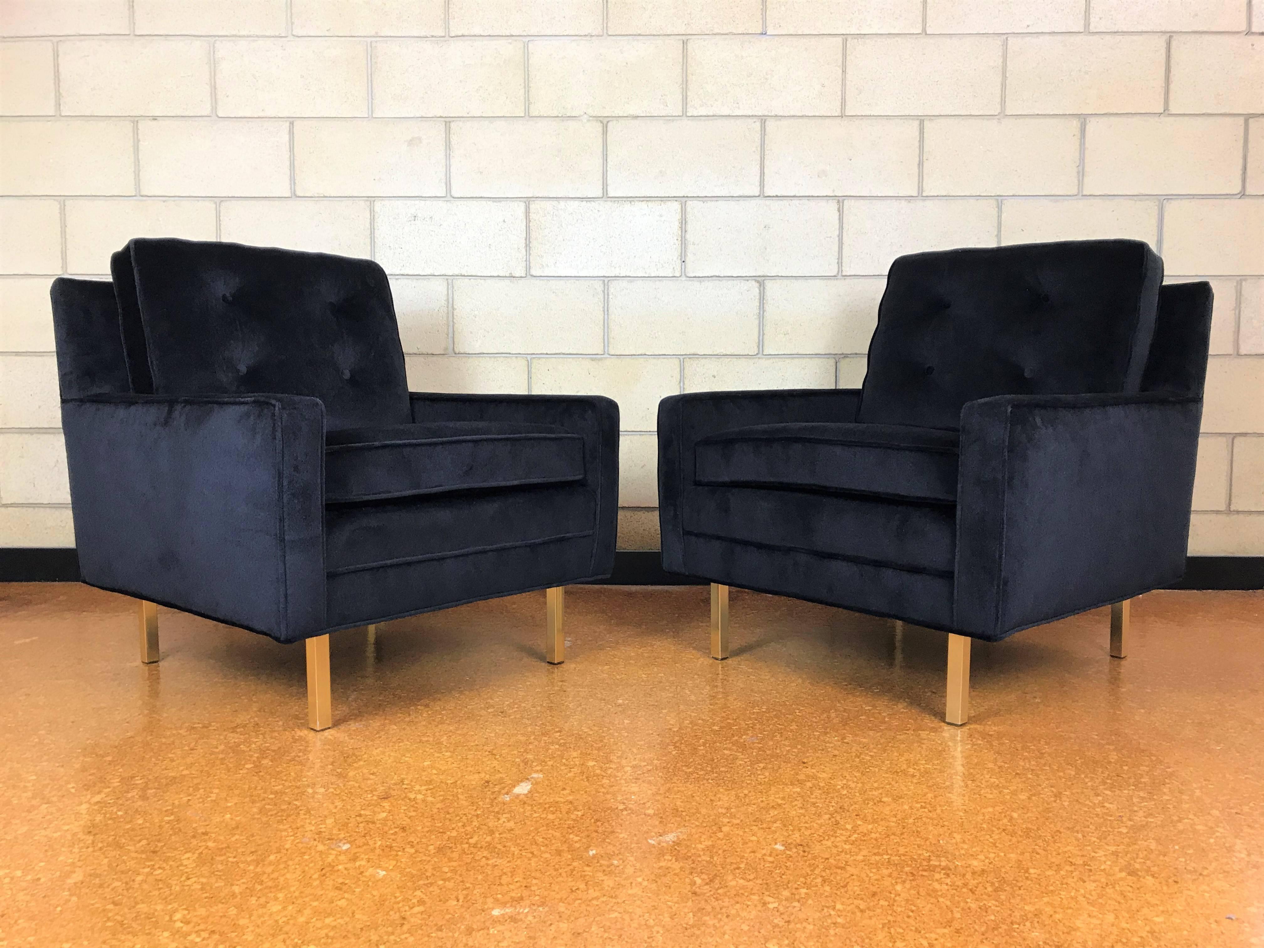 Wonderful pair of tuxedo club lounge chairs from the 1960s, maker unknown, but thought to be made by Selig based upon the construction. The brass legs are solid and the upholstery and cushions are new. Black velvet upholstery and high grade