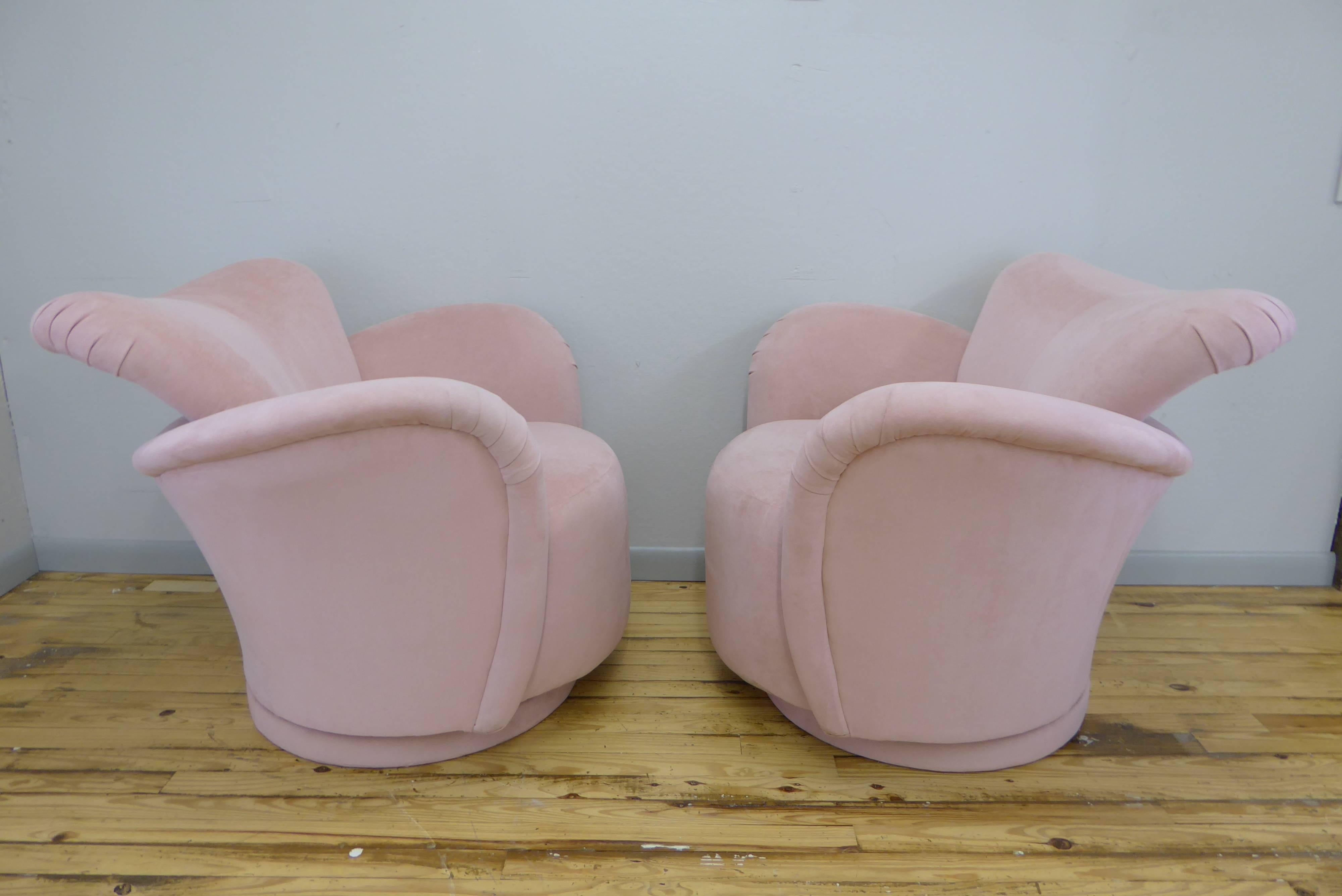 Fantastic pair of swivel chairs in the manner of Vladimir Kagan. Original blush ultrasuede upholstery. Chairs swivel, tilt and rock- incredibly comfortable pair of chairs in excellent condition. 
