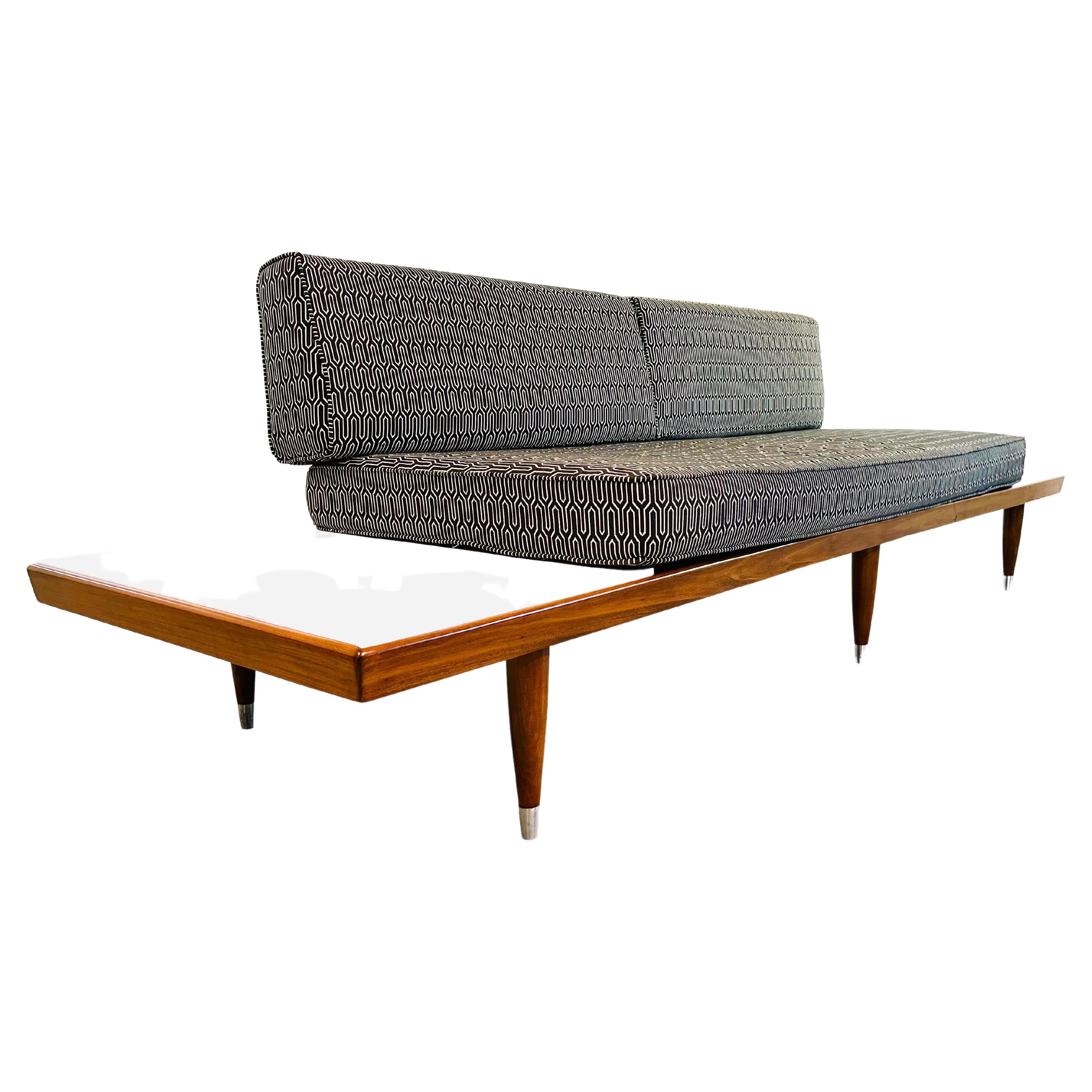 Beautiful mid-century platform sofa having Carrara marble floating shelves and a walnut frame throughout with brushed steel sabot legs. Designed and manufactured by Frank & Son of New York circa 1950. 
 In fantastic condition throughout having been