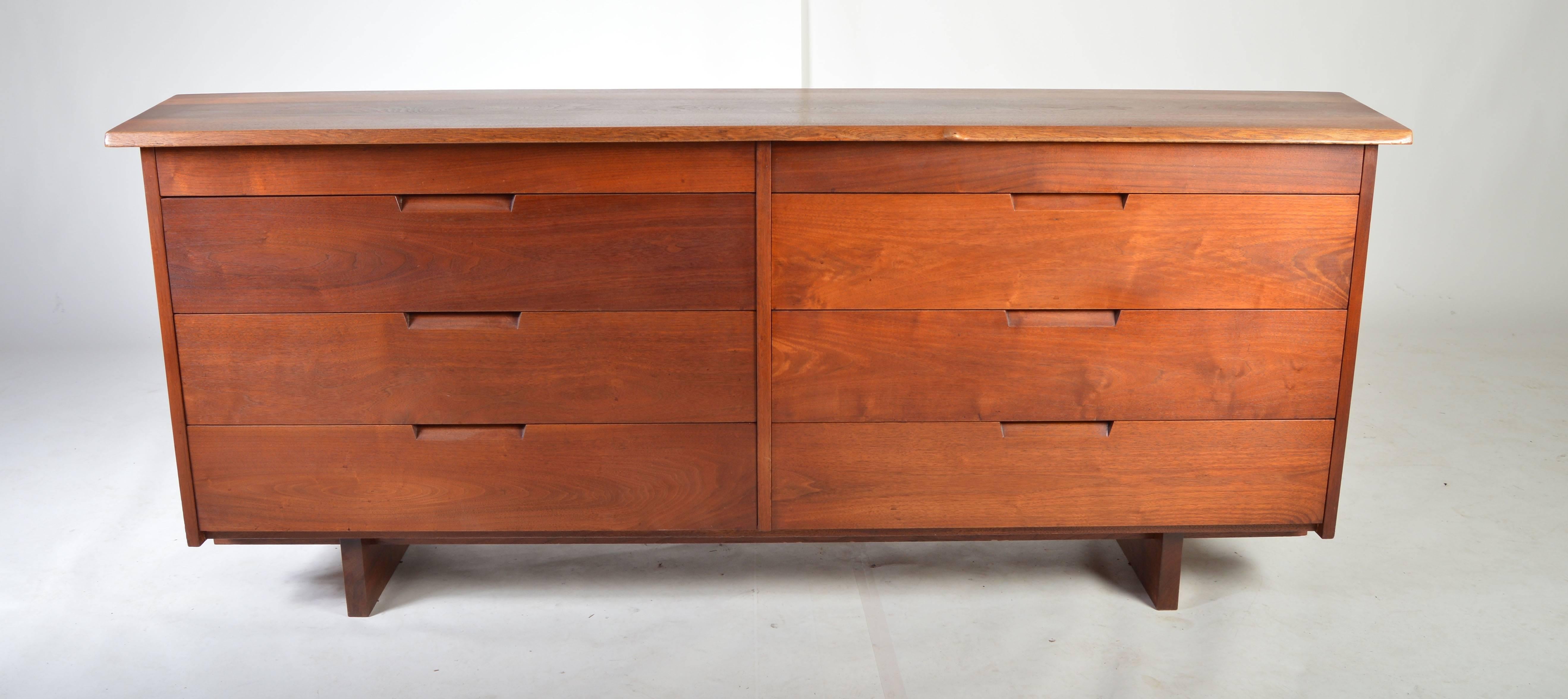A beautiful original, custom eight drawer chest by George Nakashima in solid walnut having a unique free-form branch knot along the front edge. Built in 1957. Copy of the original purchase receipt included.