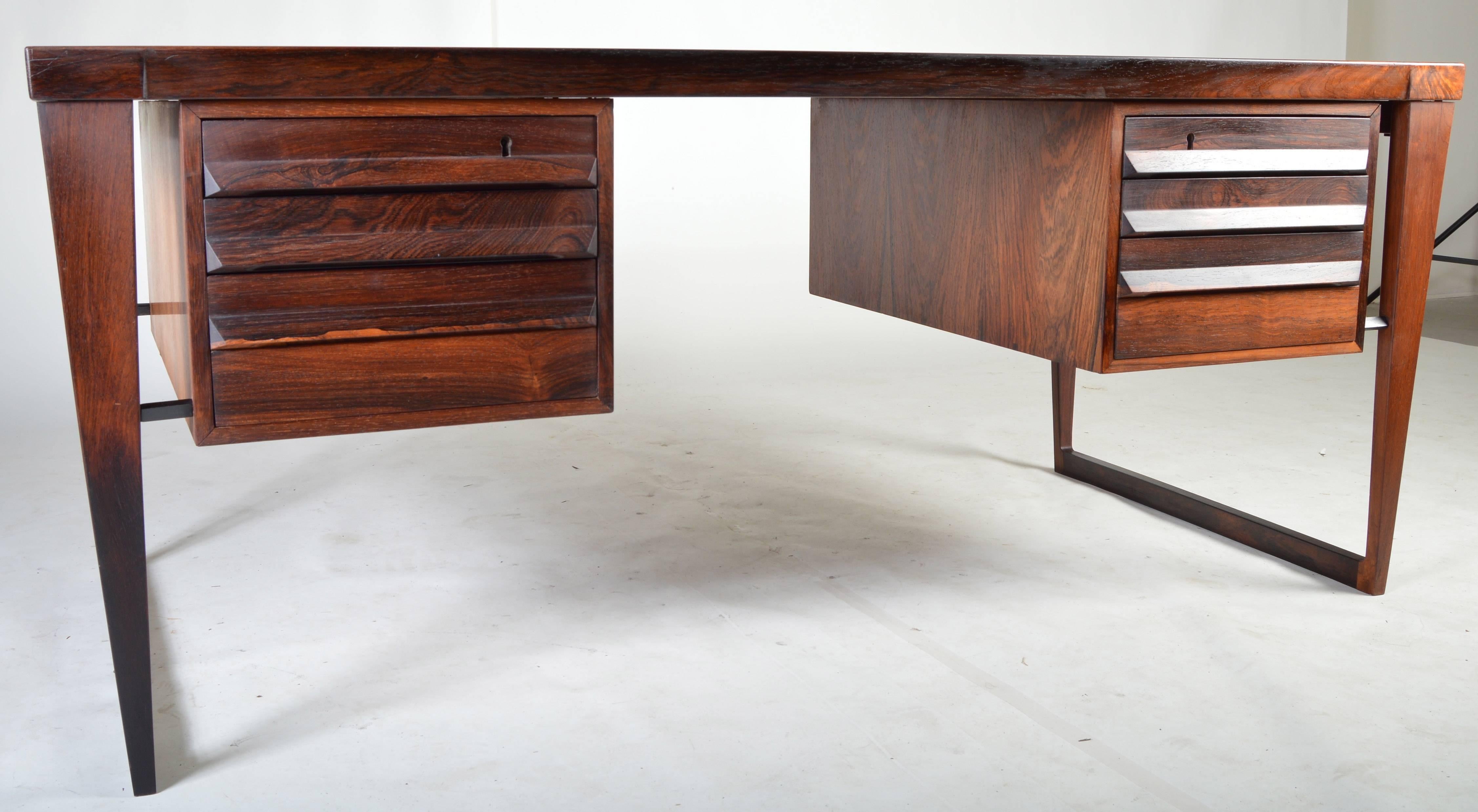 A rare and incredibly striking mid-century desk in Rosewood designed by Kai Kristiansen. A personal favorite in design, this timeless desk features sleek and simple lines while providing ample storage, surface space and functionality. 

Chair
