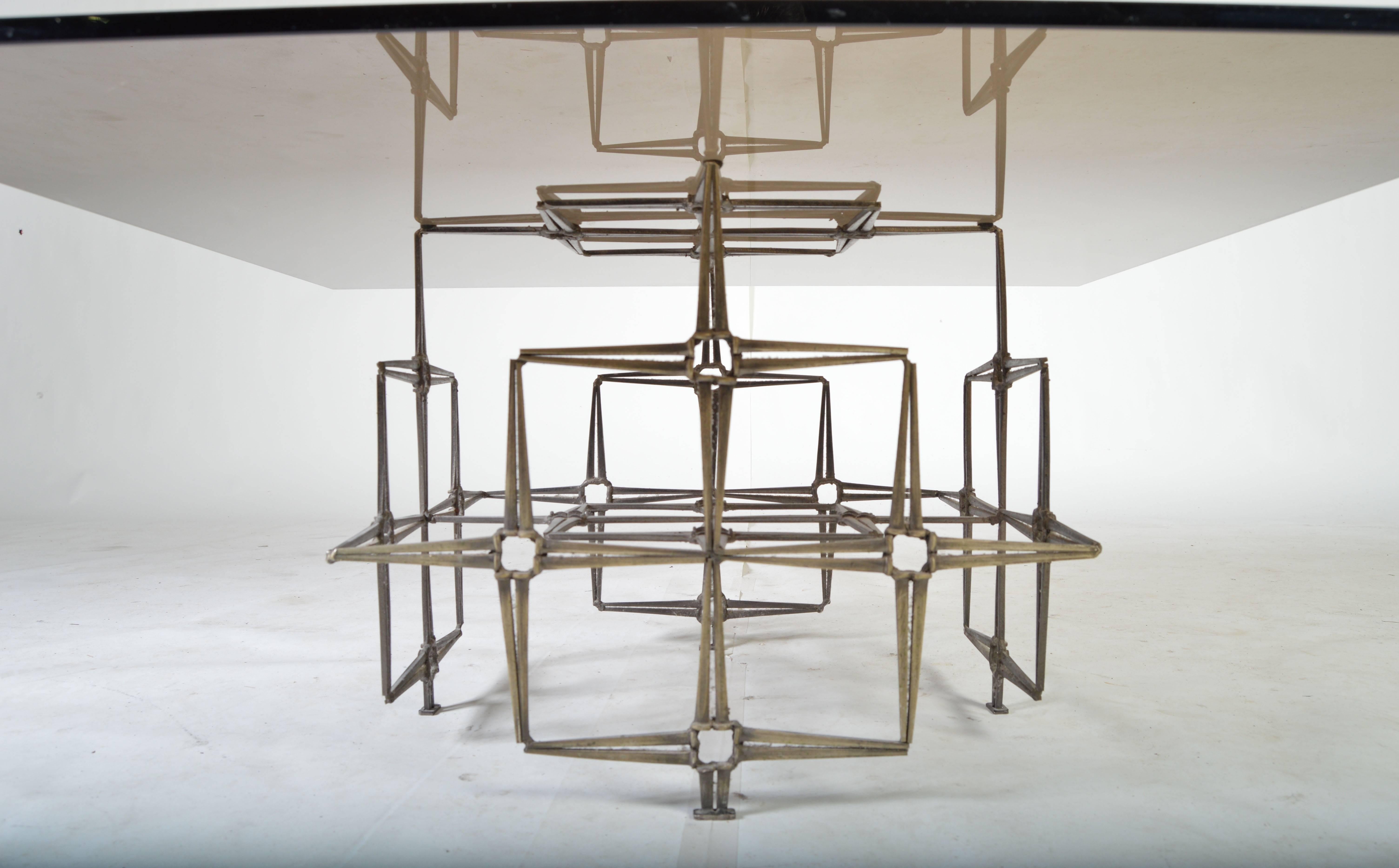 A beautiful and dramatic Brutalist cocktail table having smoked glass top and vintage wood spike sculptural base.
 Produced by Tri-Mark Designs