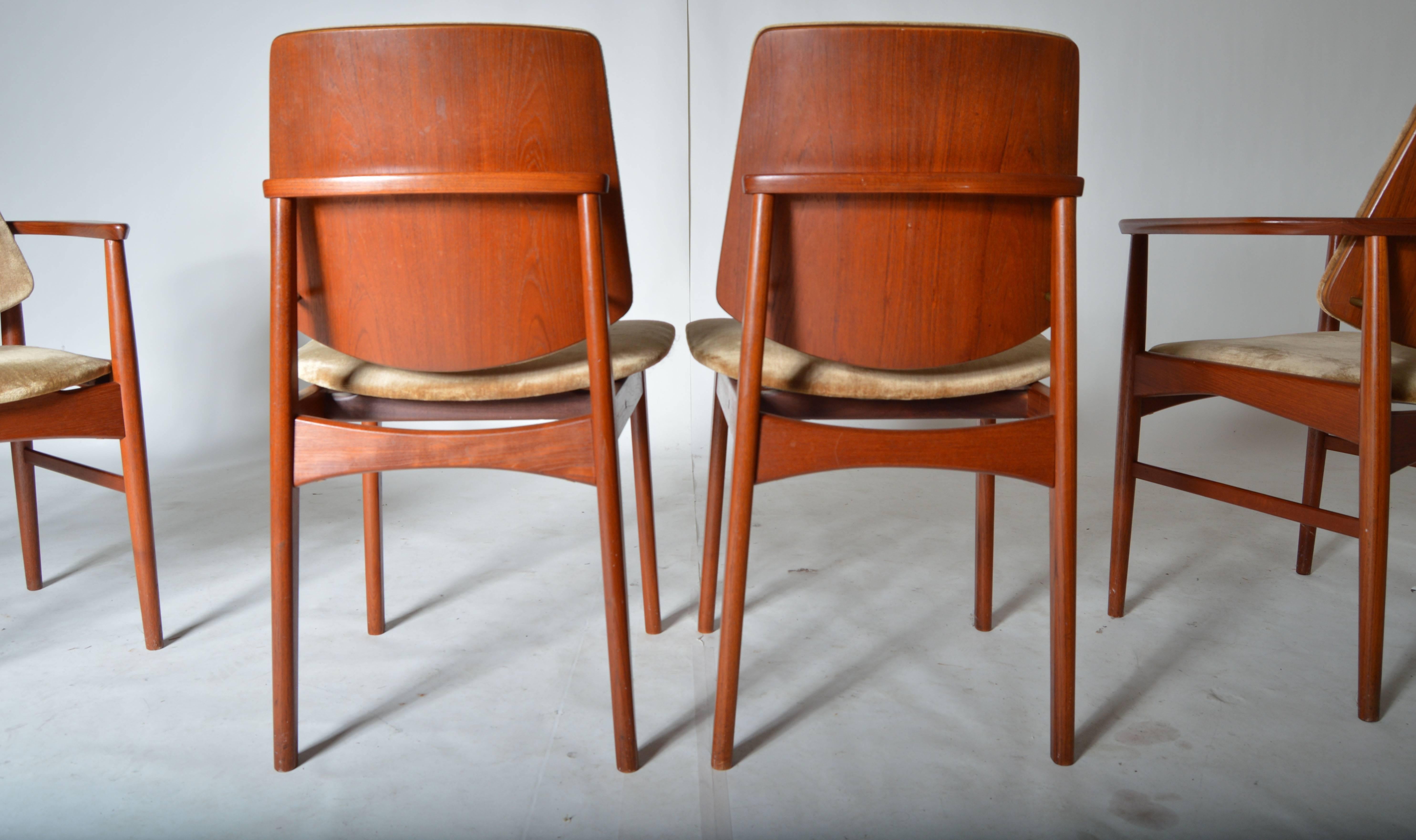 A beautiful set of eight teak framed dining chairs having bentwood teak backs and seats with smooth polyester upholstery. Stunning.