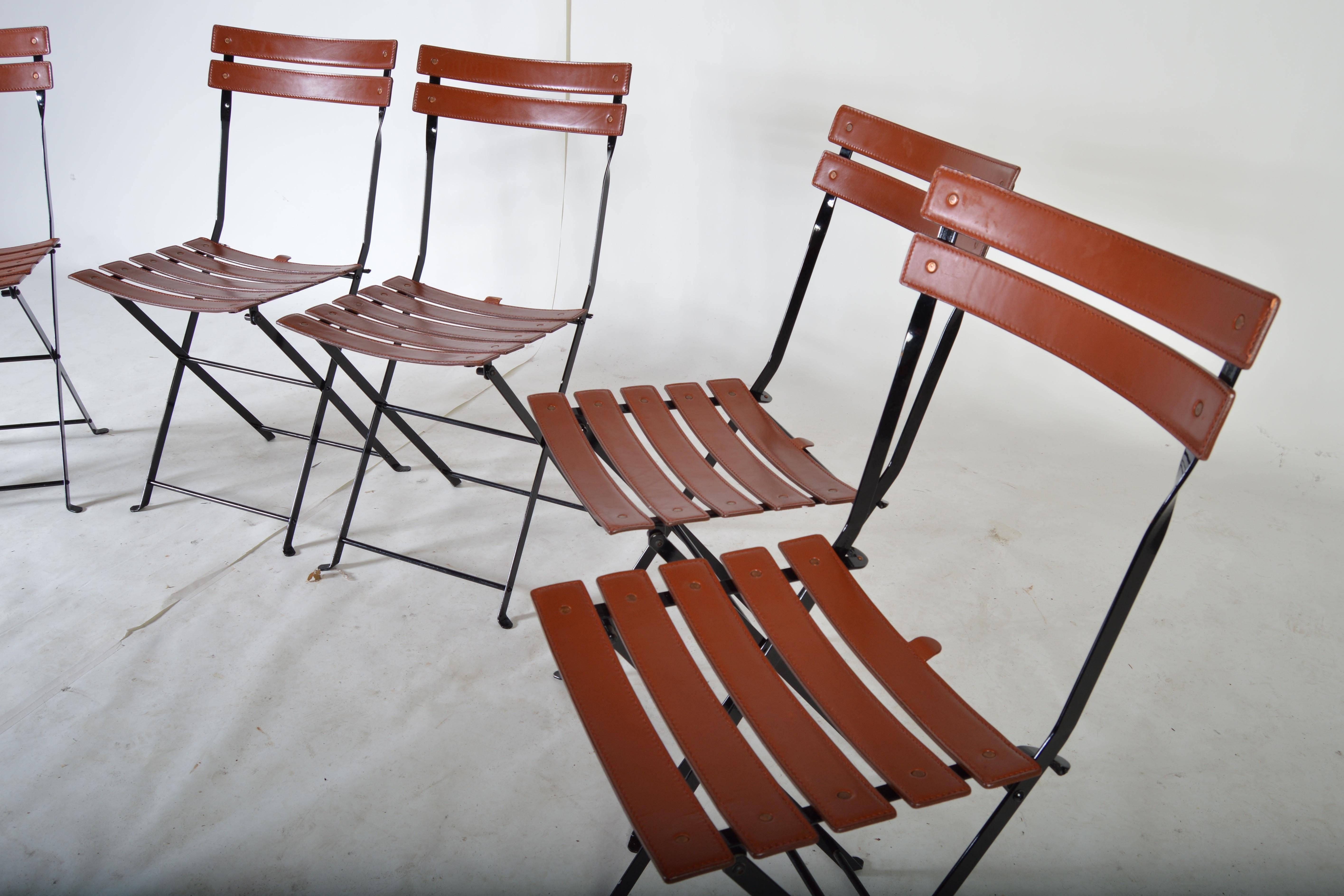 A beautiful set of vintage Marco Zanuso "Celestina" folding chairs having leather seat and backrest with iron frames. In fantastic vintage condition.