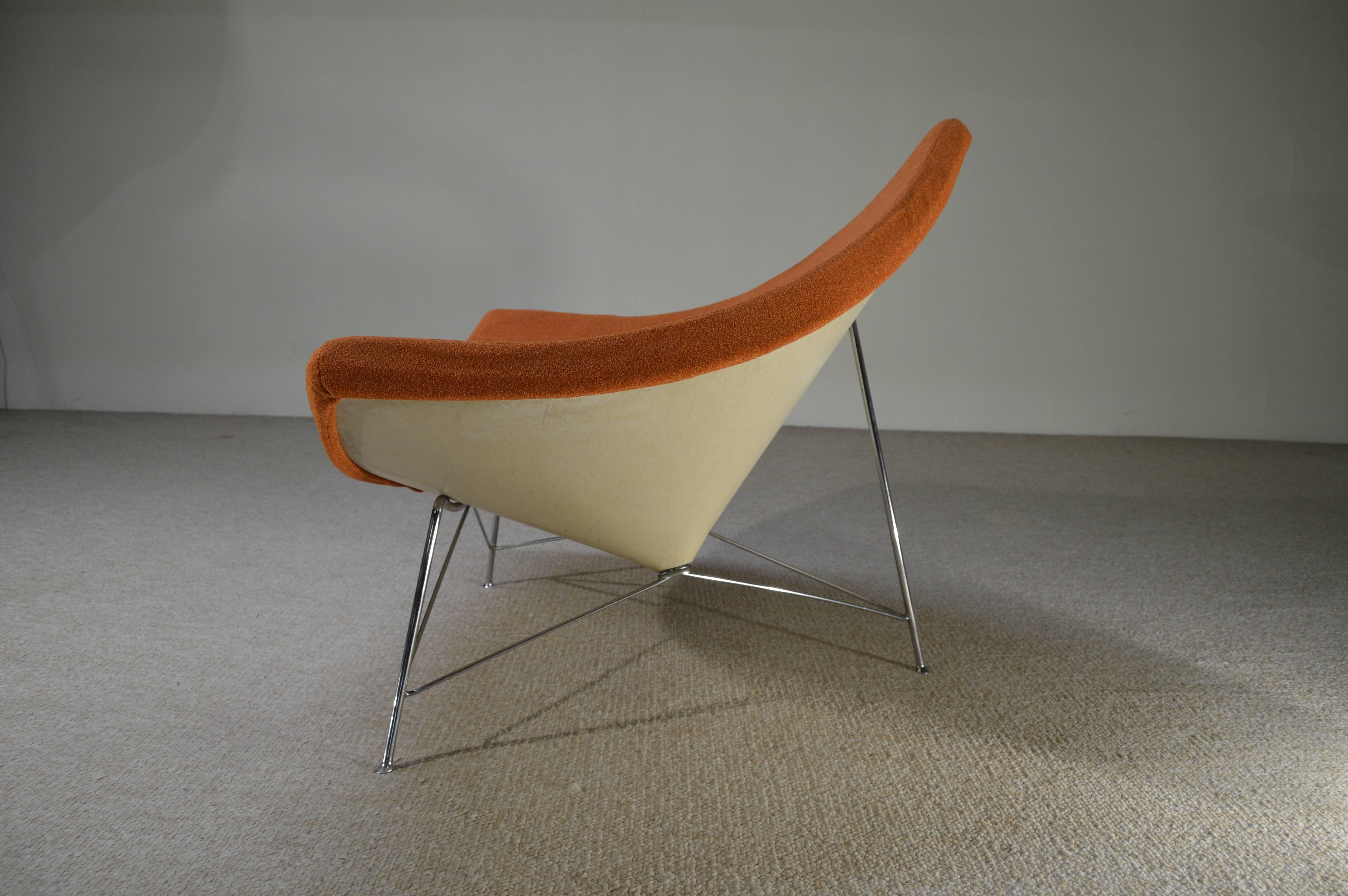 An early example of George Nelson's iconic Coconut Lounge chair produced by Herman Miller. 
 Beautiful condition though the upholstery should be replaced having a poor cross stitch. This design features a steel cable release for easy reupholstery
