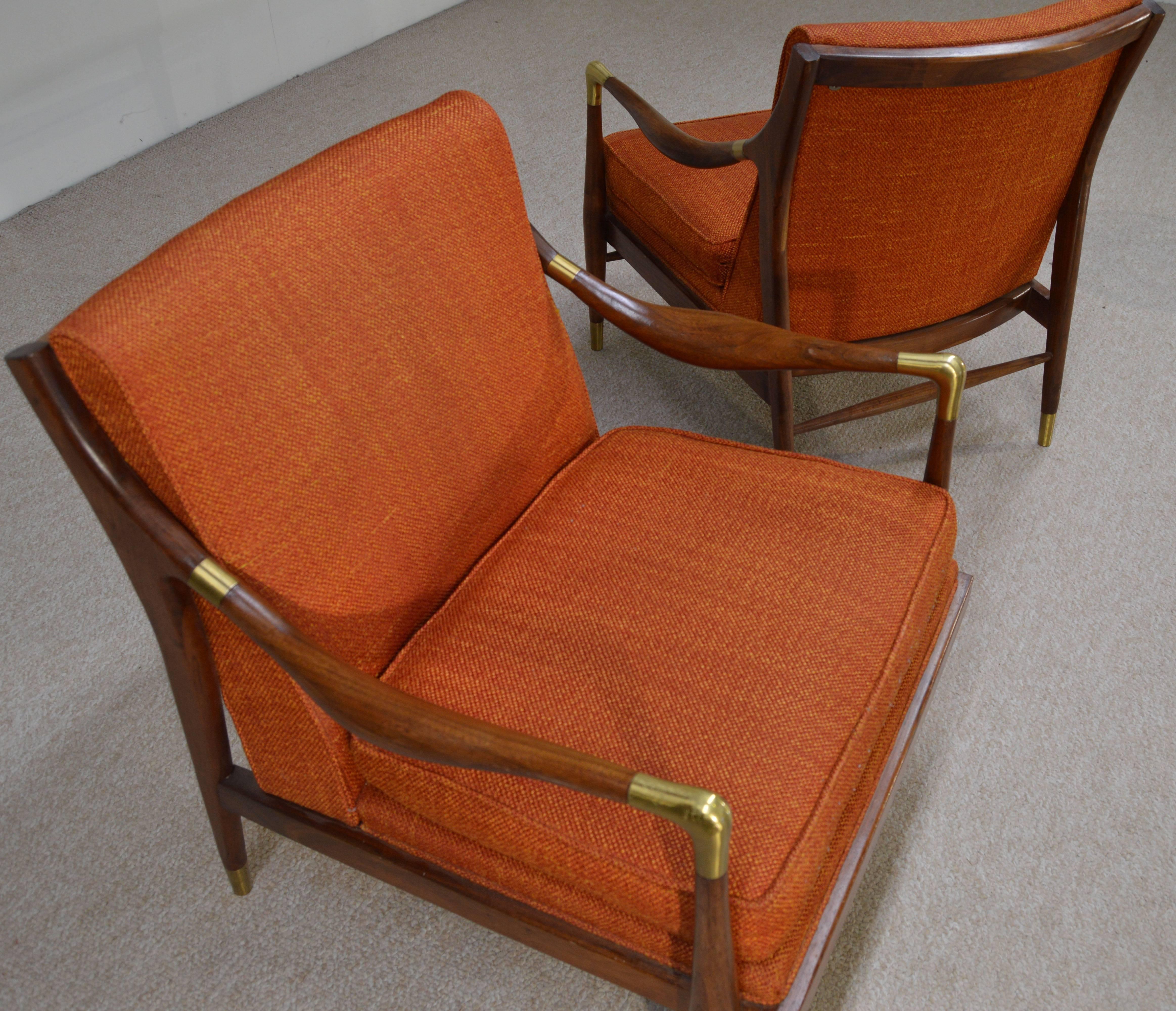 A gorgeous pair of sculptural solid walnut lounge chairs with brass accents on arms and sabots in the style of Gio Ponti by Jamestown Royal.