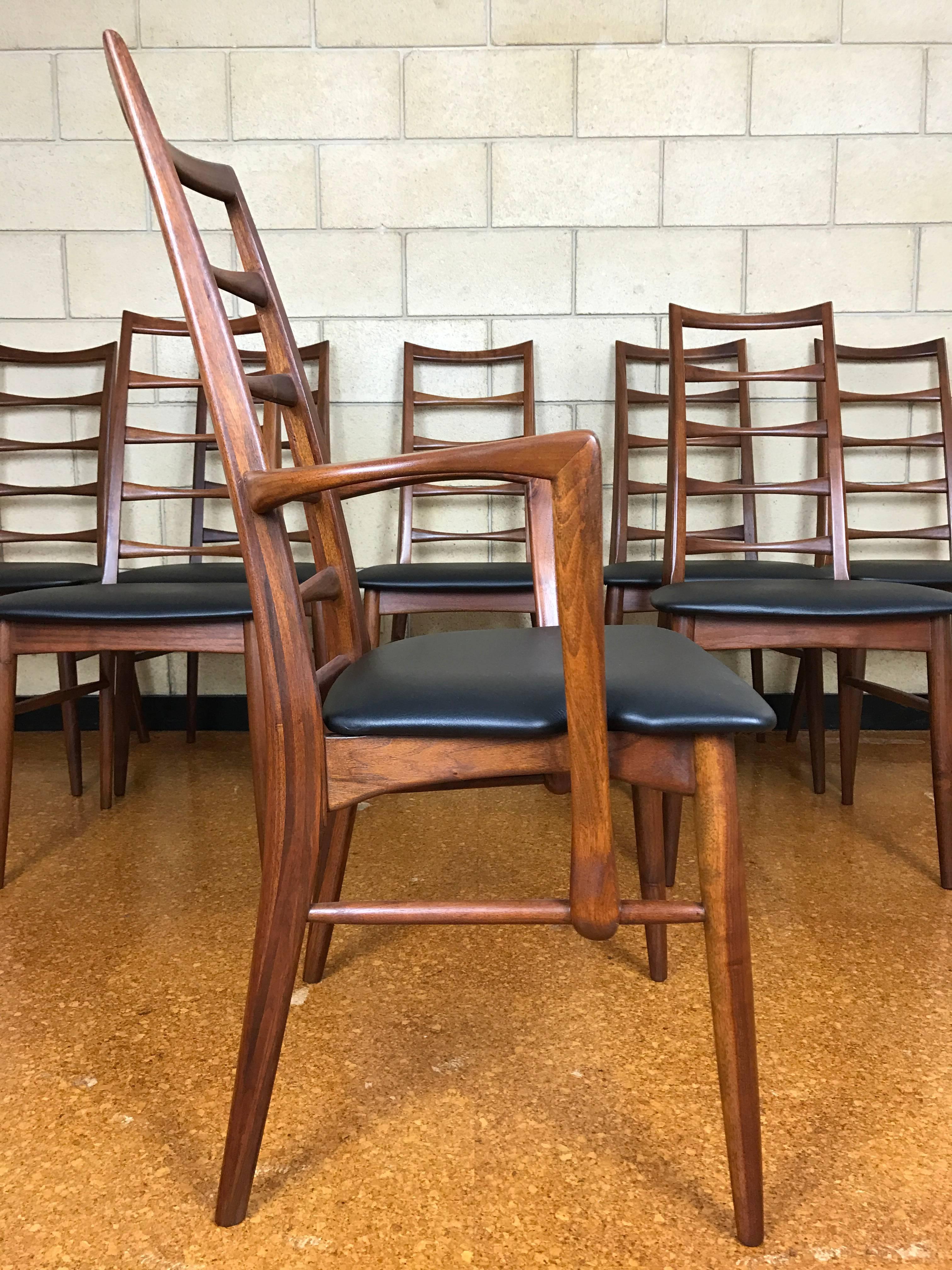 Eight Niels Koefoed for Koefoed Hornslet 'Liz' ladder-back dining chairs in walnut and Naugahyde, 1960s. Completely restored - frames refinished and new upholstery. 

Side chairs: 18.5 wide x 21 deep (top of back to front) x 37.5 tall. 
Armchair: