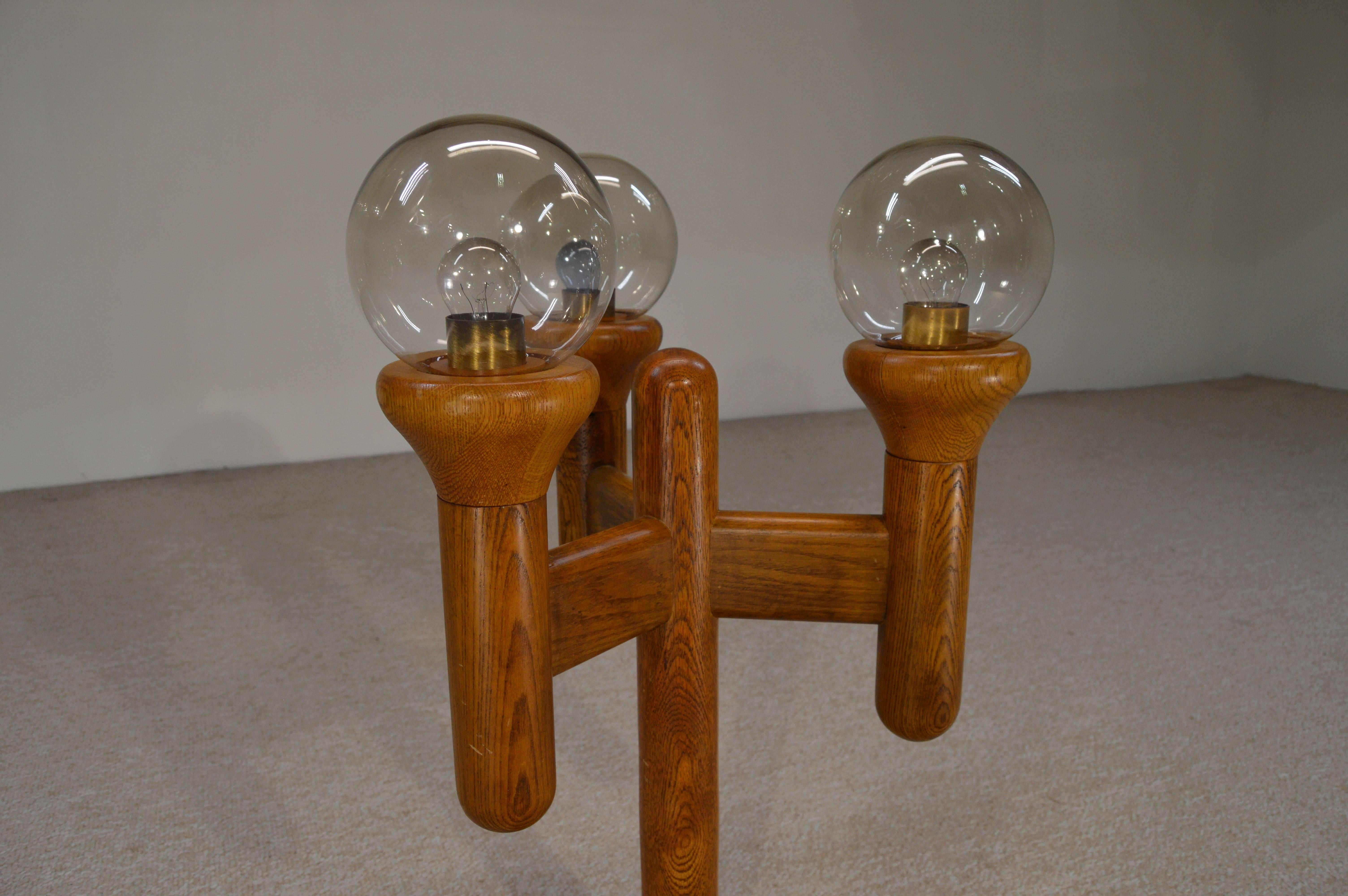 An awesome lamp constructed of solid oak carefully selected for its grain patterns and dawning three clear retro glass globes. Features a dimmer switch. Tested and functioning perfectly, circa 1960.