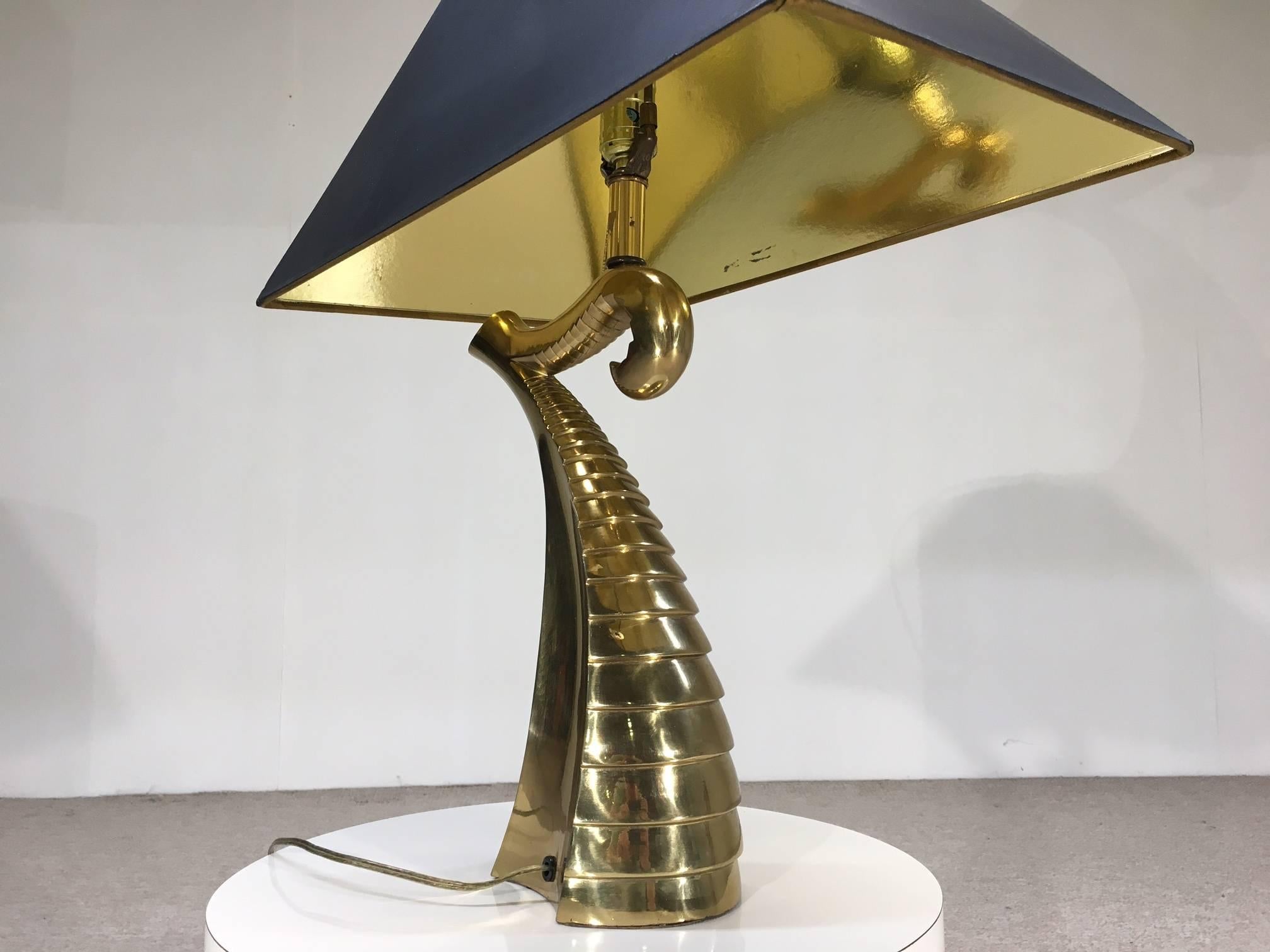 A stunning brass sculptural lamp circa 1970 having a dragon tentacle or Kracken arm base and gold interior shade. Designer or creator is unknown but resembles the work of Philippe Jean of France and Pierre Cardin. 

Sculpture dimensions inches:
