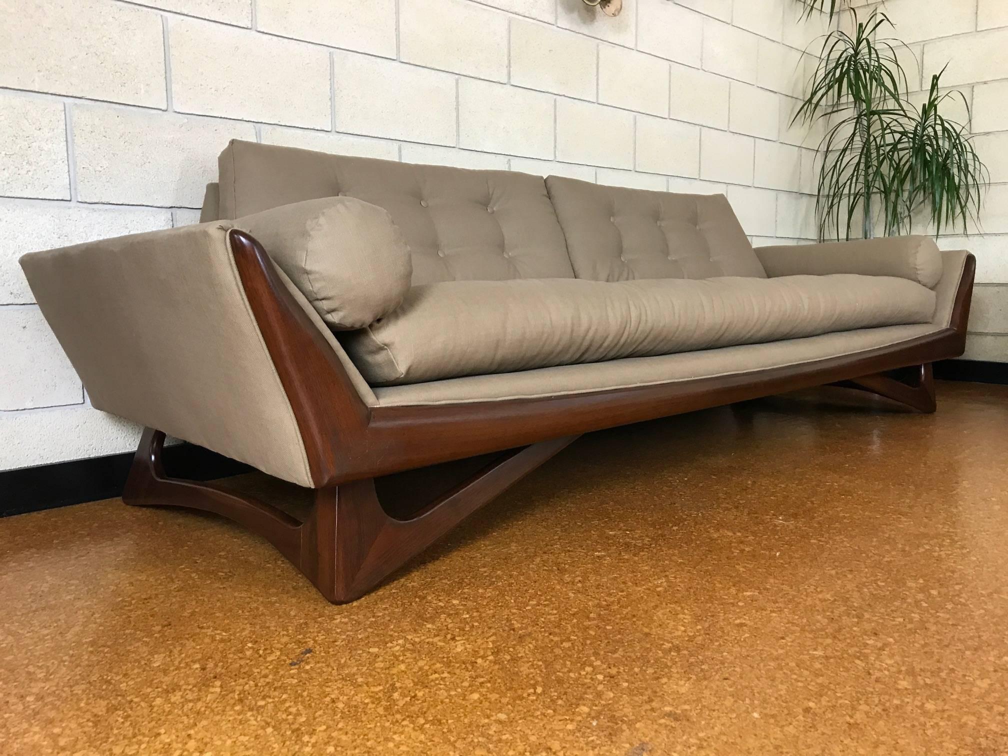 Reupholstered in light taupe fabric. Walnut legs and trim refinished/restored. 

Measures: Sofa is 103 x 33 deep x 29 tall. Seat height is 18".
Chair 34.5" wide x 33" deep x 29" tall. Seat height is 17" 

Original label