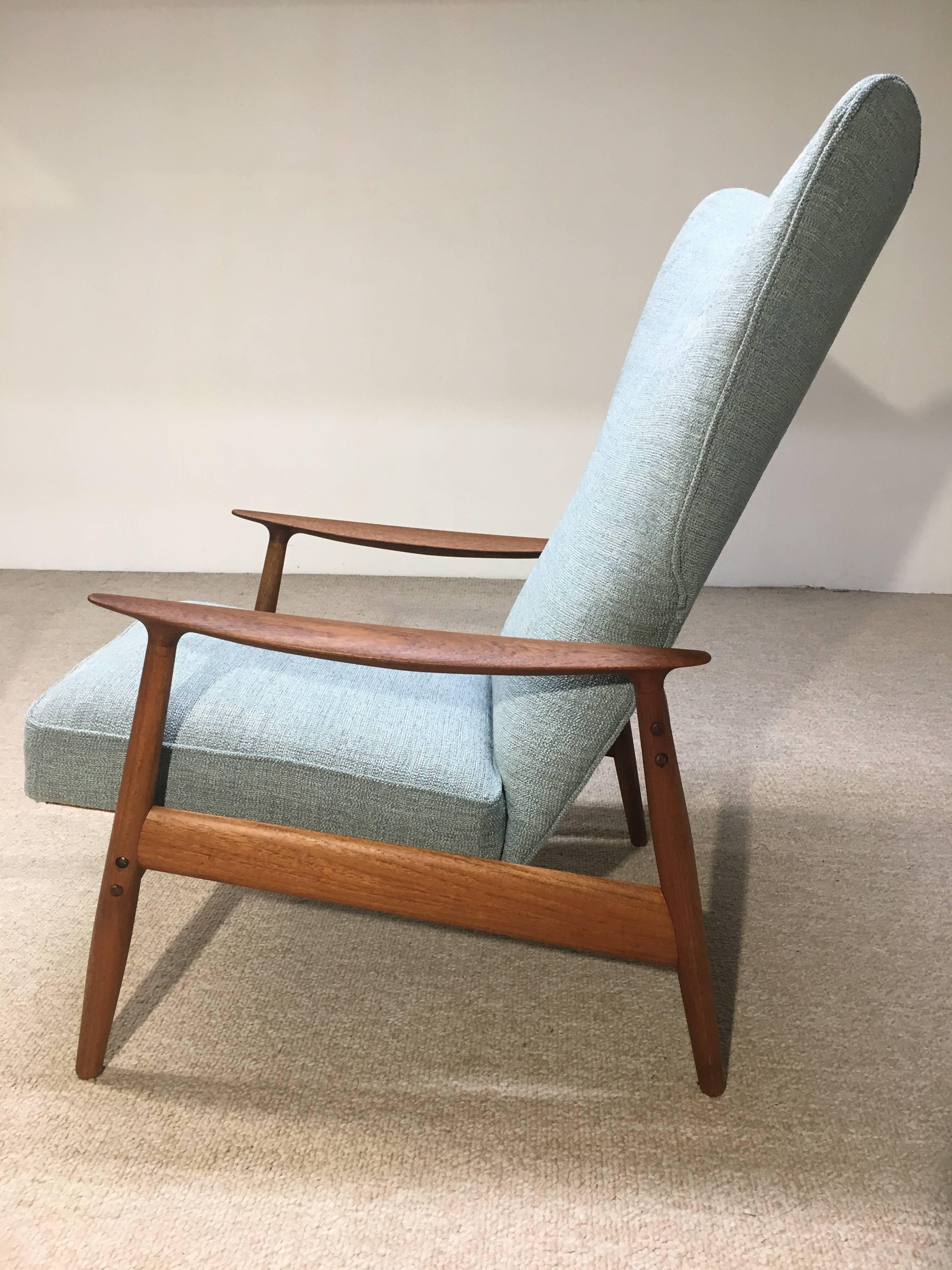 Danish lounge chair in teak and soft light blue textured tweed by K. Rasmussen for Peter Wessel. Reupholstered with new cushions. Reclines. 

Measures: Chairs 28