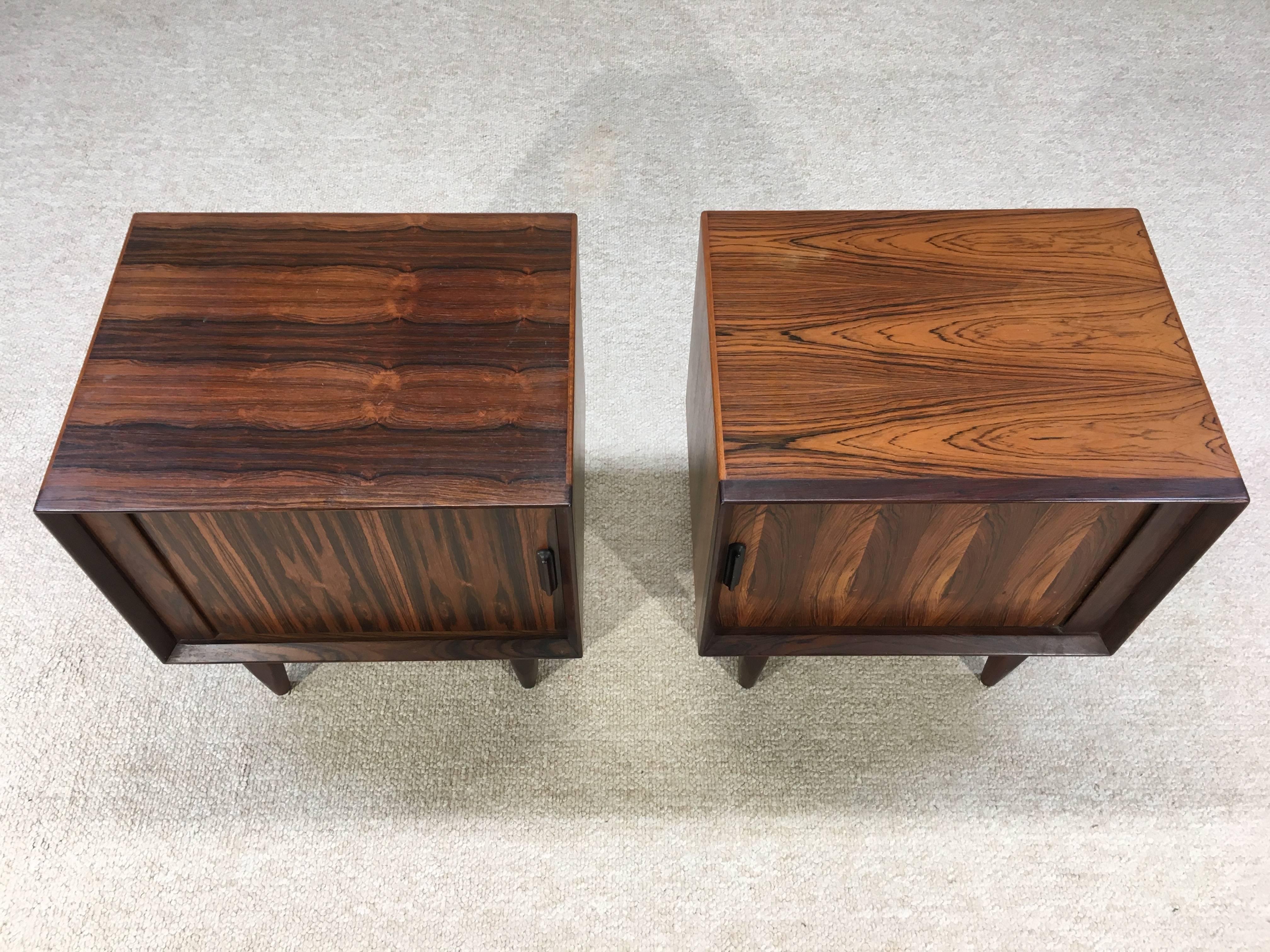 A beautifully grained pair of Brazilian rosewood nightstands having tambour doors by Arne Wahl Iversen for Falster Denmark.