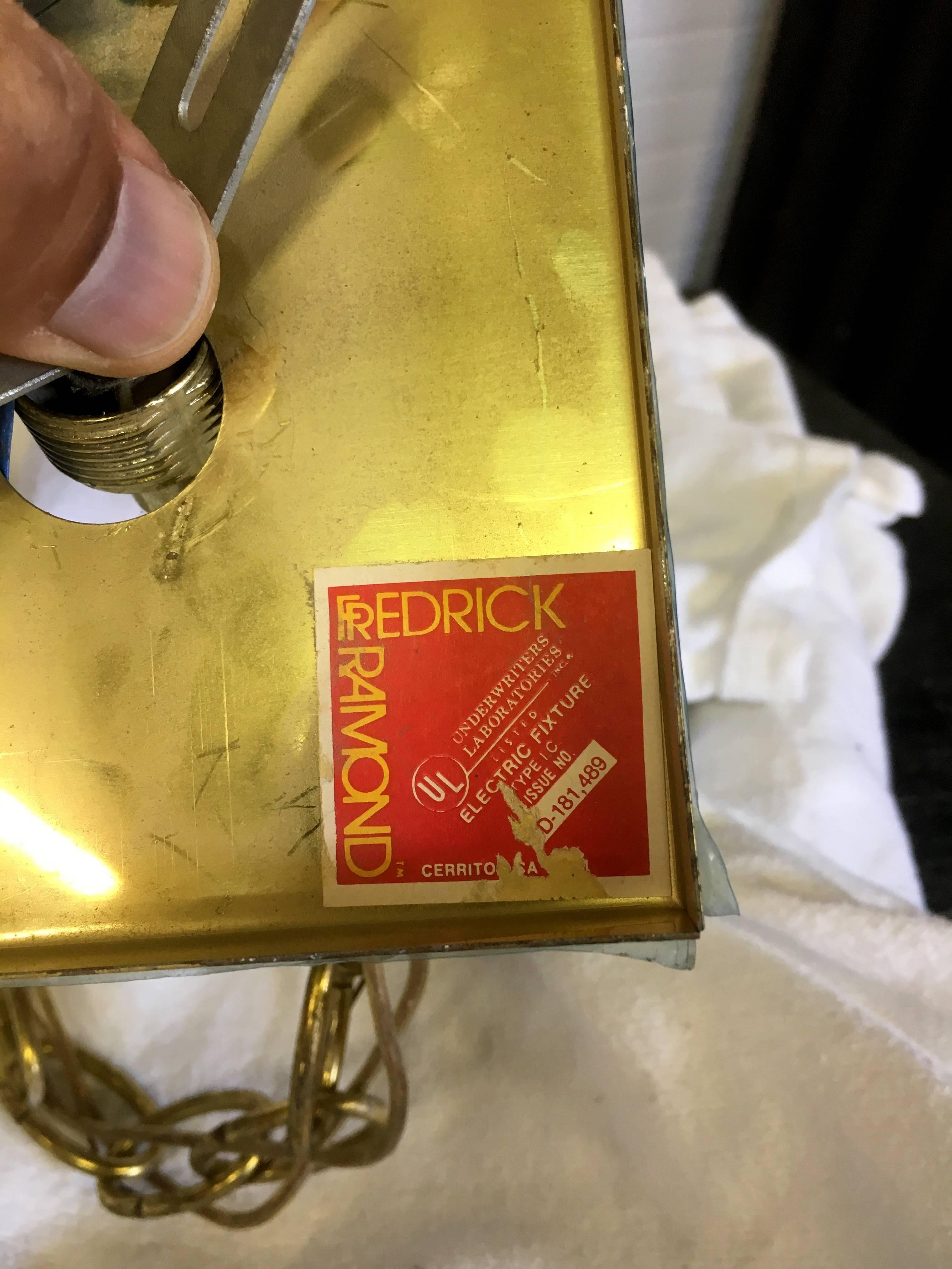 Swank brass and smoked glass chandelier by Fredrick Ramond.
Label is still displayed on the inside of the ceiling mount.
Great condition although, while cleaning, I discovered a sliver of a chip on an edge. Please see photo. Hard to see.
This