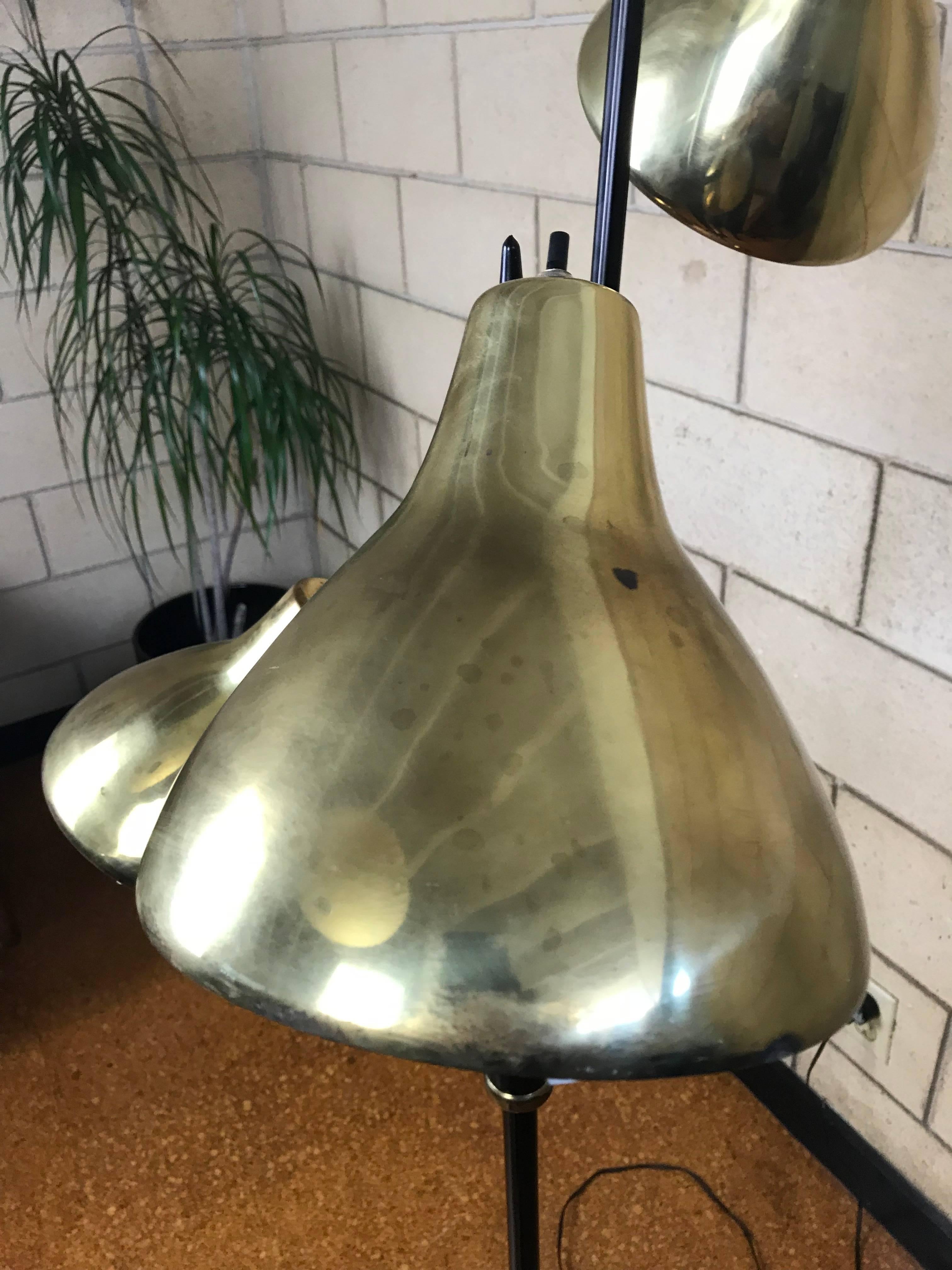 Wonderful and original three shade floor lamp designed by Gerald Thurston for Lightolier. This lamp is in original condition and each shade is movable and they have their original nautilus style diffusers which is very rare. The brass shades do show