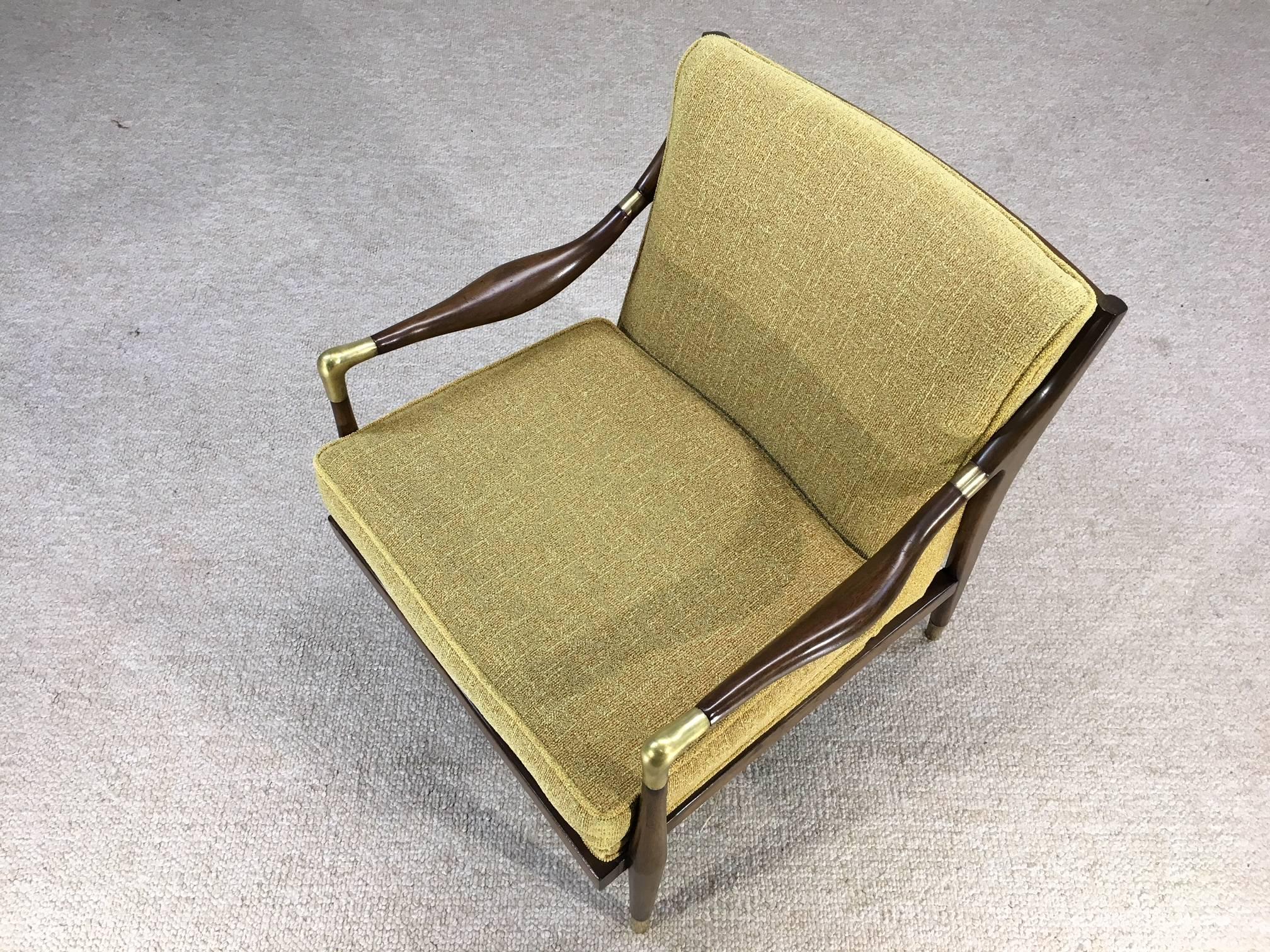A graceful midcentury open armchair by Jamestown Royal having sculptural walnut arms, brass accents and sabots.
Beautiful condition having original upholstery, circa 1950.

Measures: Seat height 17