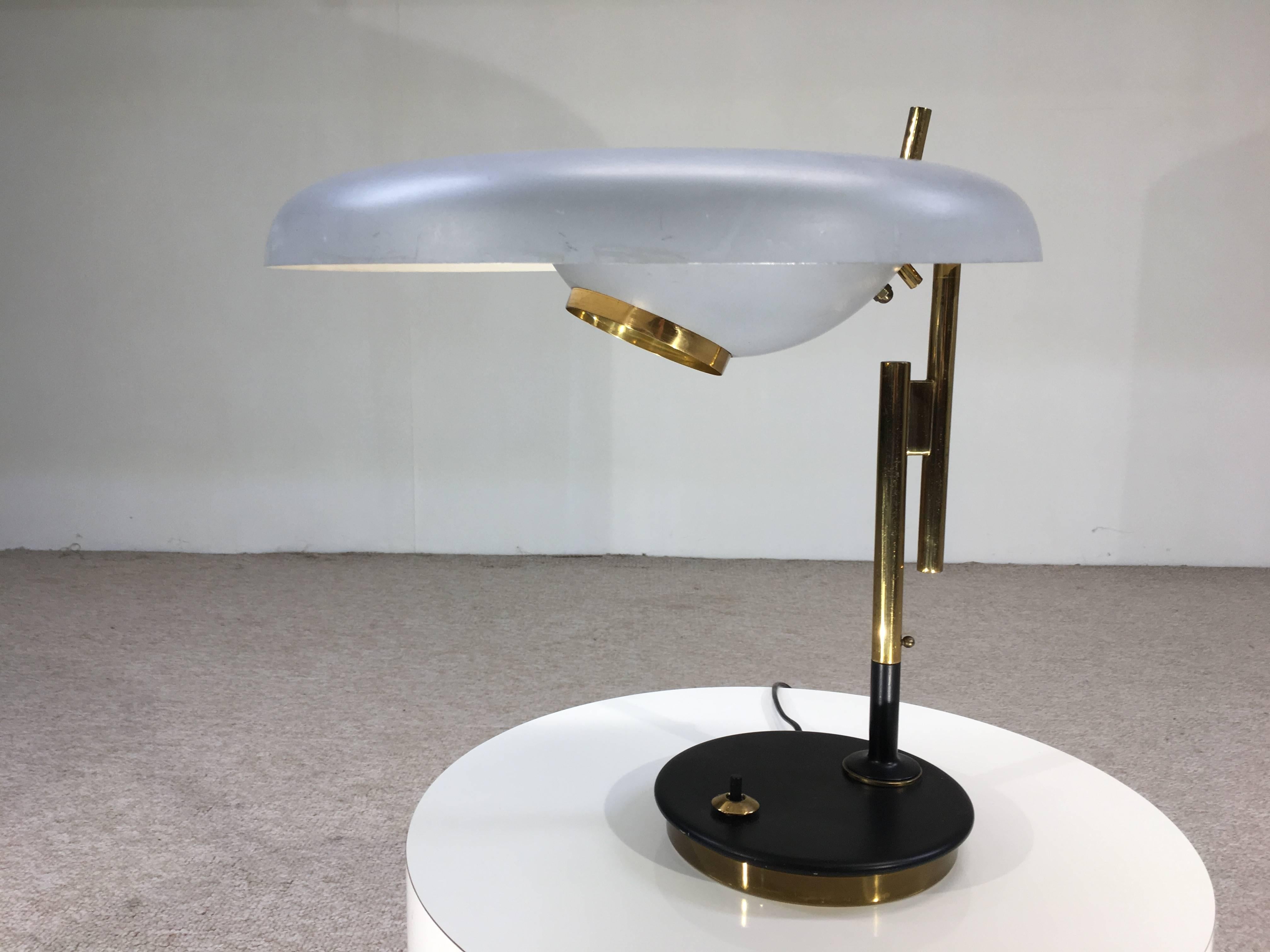 A magnificent design by one of the Italian greats. Oscar Torlasco's Magnification lamp design concentrates light with a greater focus on the work area. It is also completely adjustable being able to rotate completely around to light a room. 

