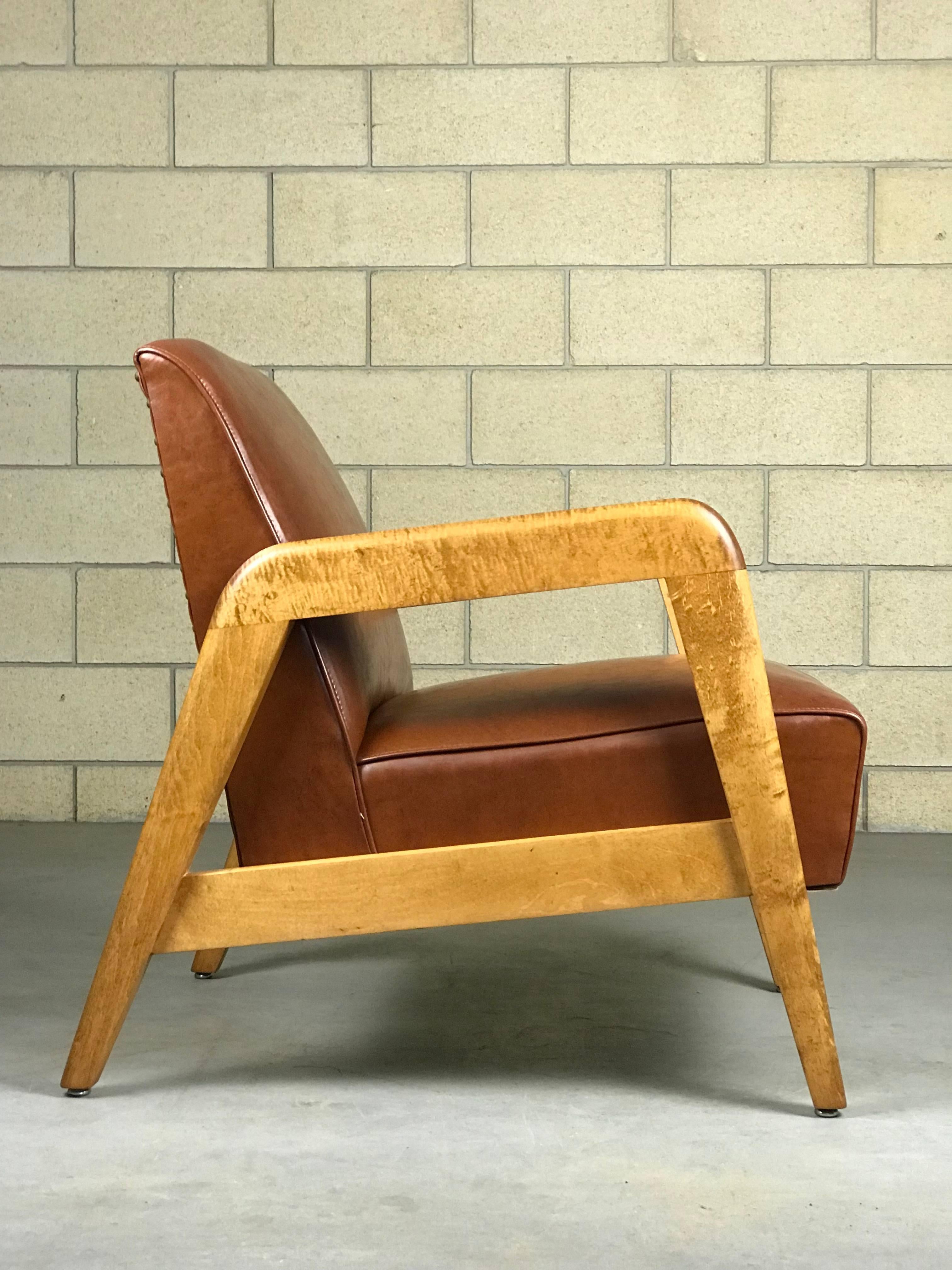 Beautiful lounge chair designed by Russel Wright for Thonet in vinyl & wood. The wood is tiger maple solid. The frame has been refinished. Although, there were a few nicks I was unable to sand out. Please see pictures. The vinyl is early nailed in