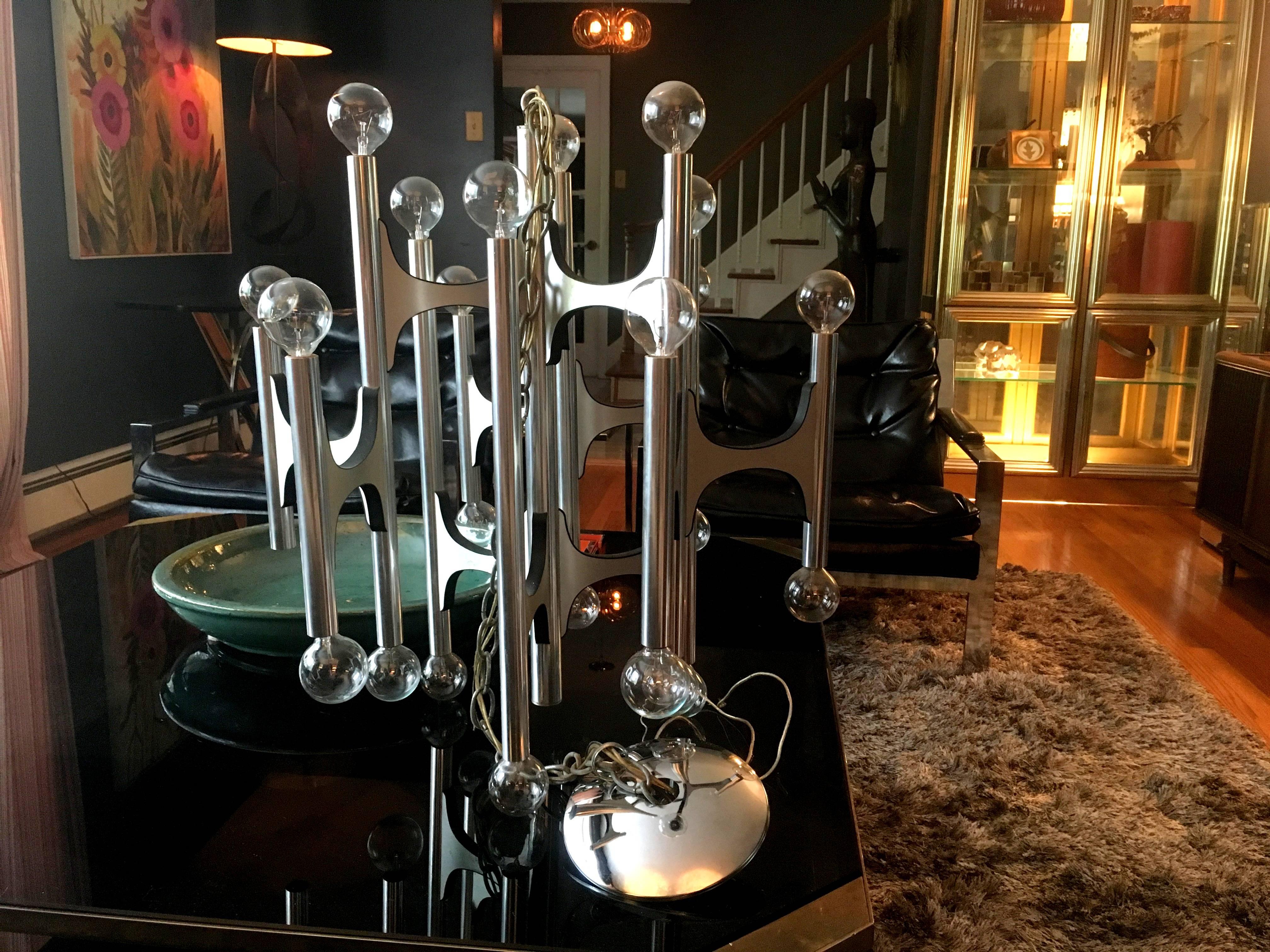 Stunning 24 bulb brushed aluminum chandelier by Gaetano Sciolari. Lightolier label still present.
This piece is a work of art with its architectural lines. I chose clear bulbs for it but you can easily replace them with frosted or white