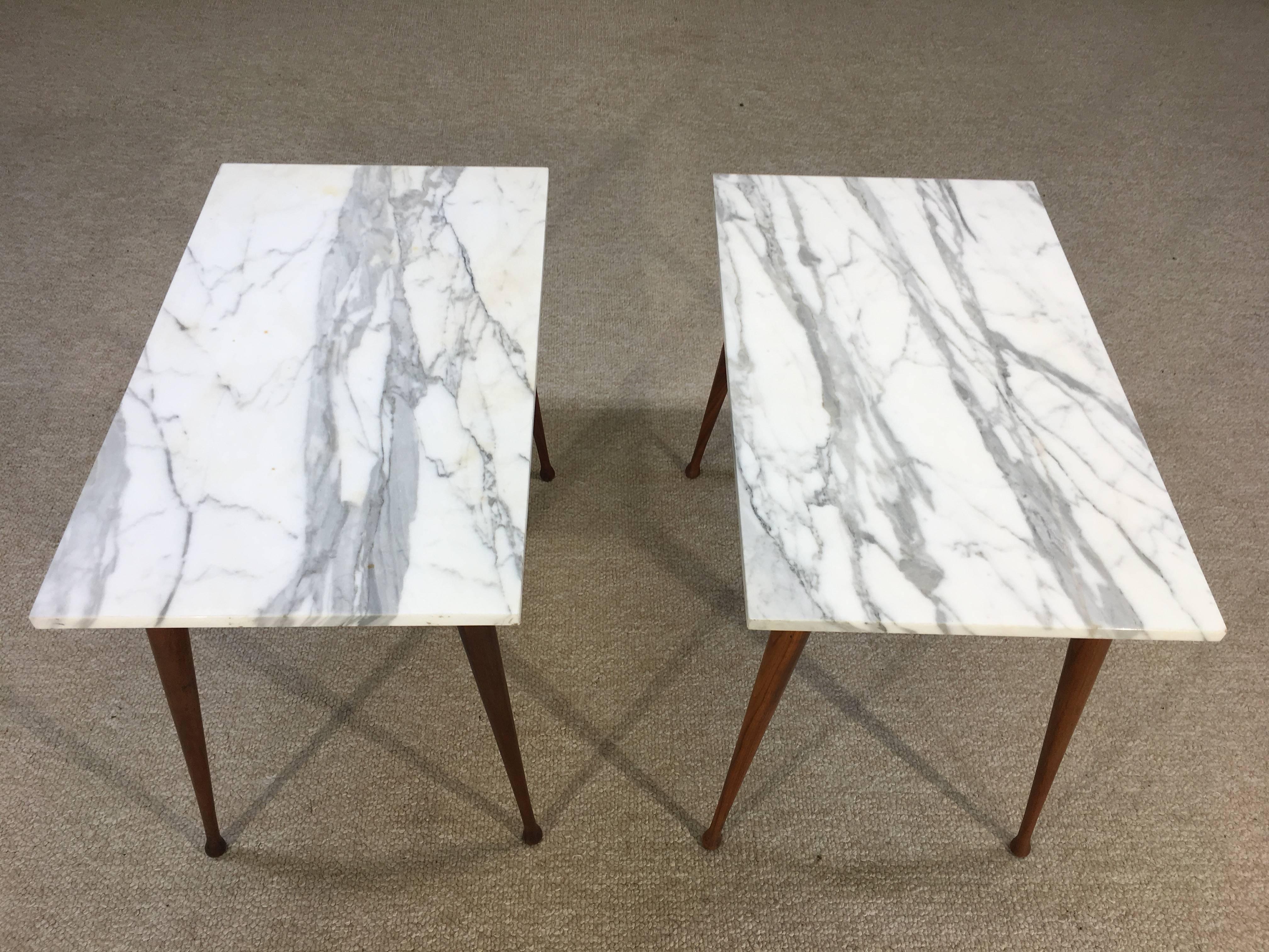 A beautiful matched pair of Paul Mccobb Carrara marble-top side tables having steel under frame and splayed birch drumstick legs, circa 1955.
