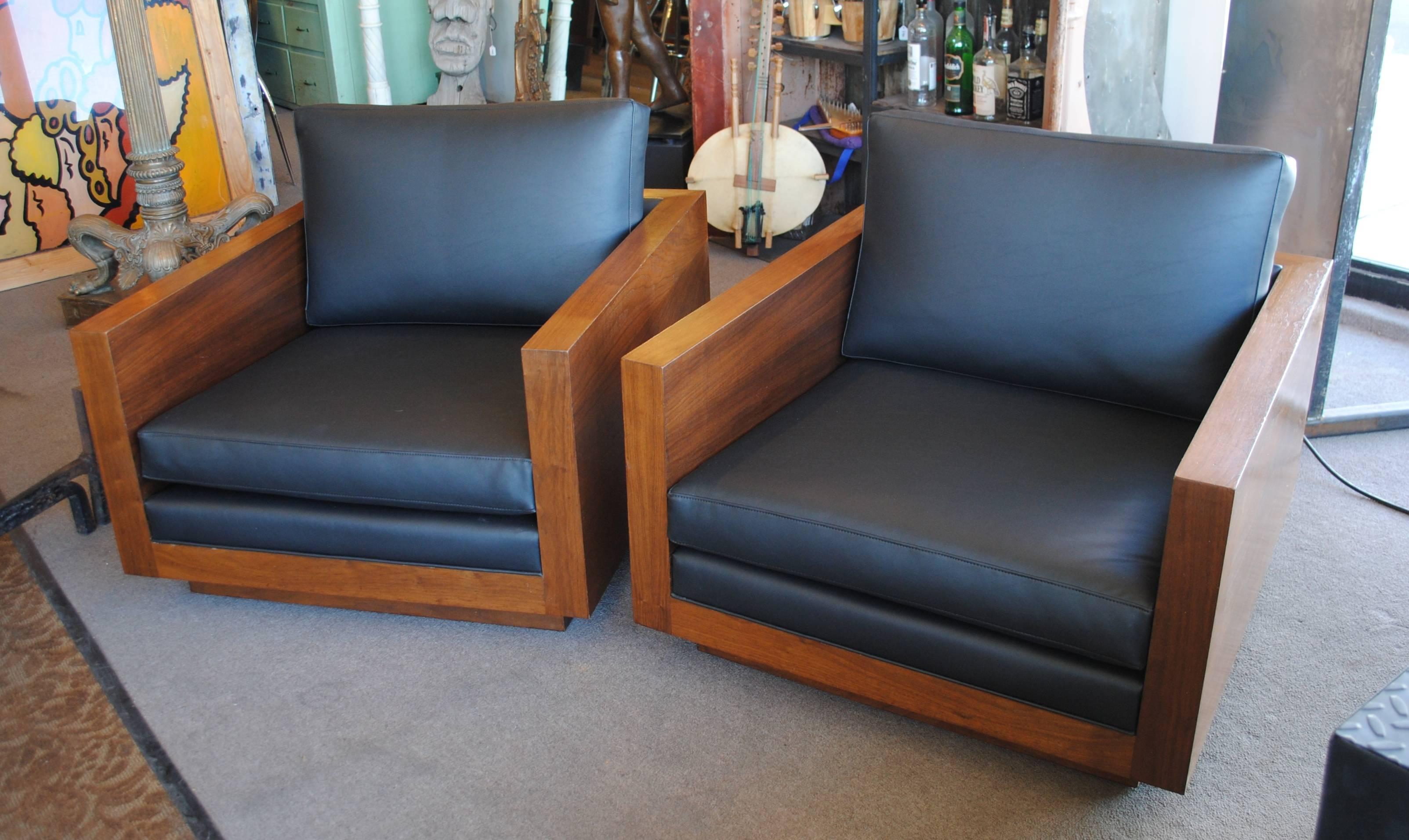 Gorgeous pair of walnut cube chairs on plinth base. In very nice vintage condition. The walnut veneer is in overall good condition with restored flea bites on the armrests.