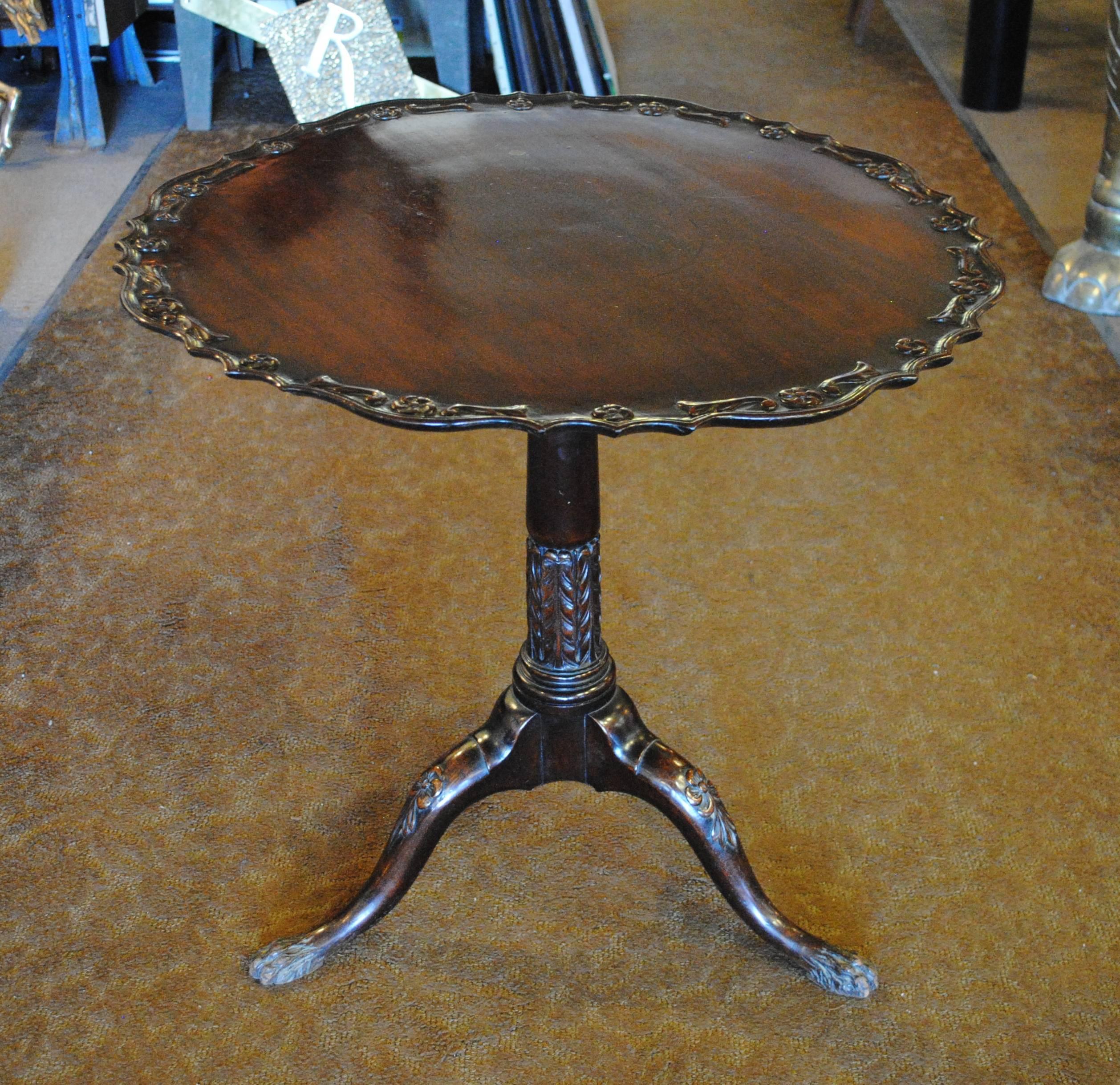 Chippendale style mahogany tilt-top table with pie crust edging, carved out of a solid board.