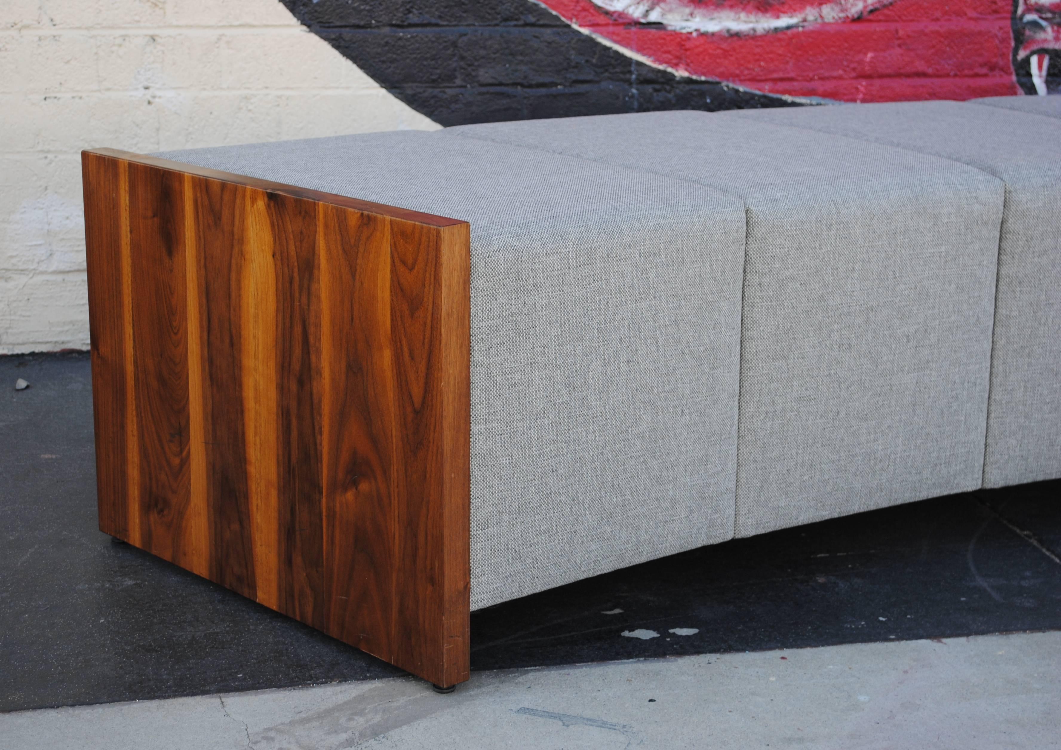 Large modern curved bench. Custom-made in walnut and new upholstery in grey tweed. Measures 12.3