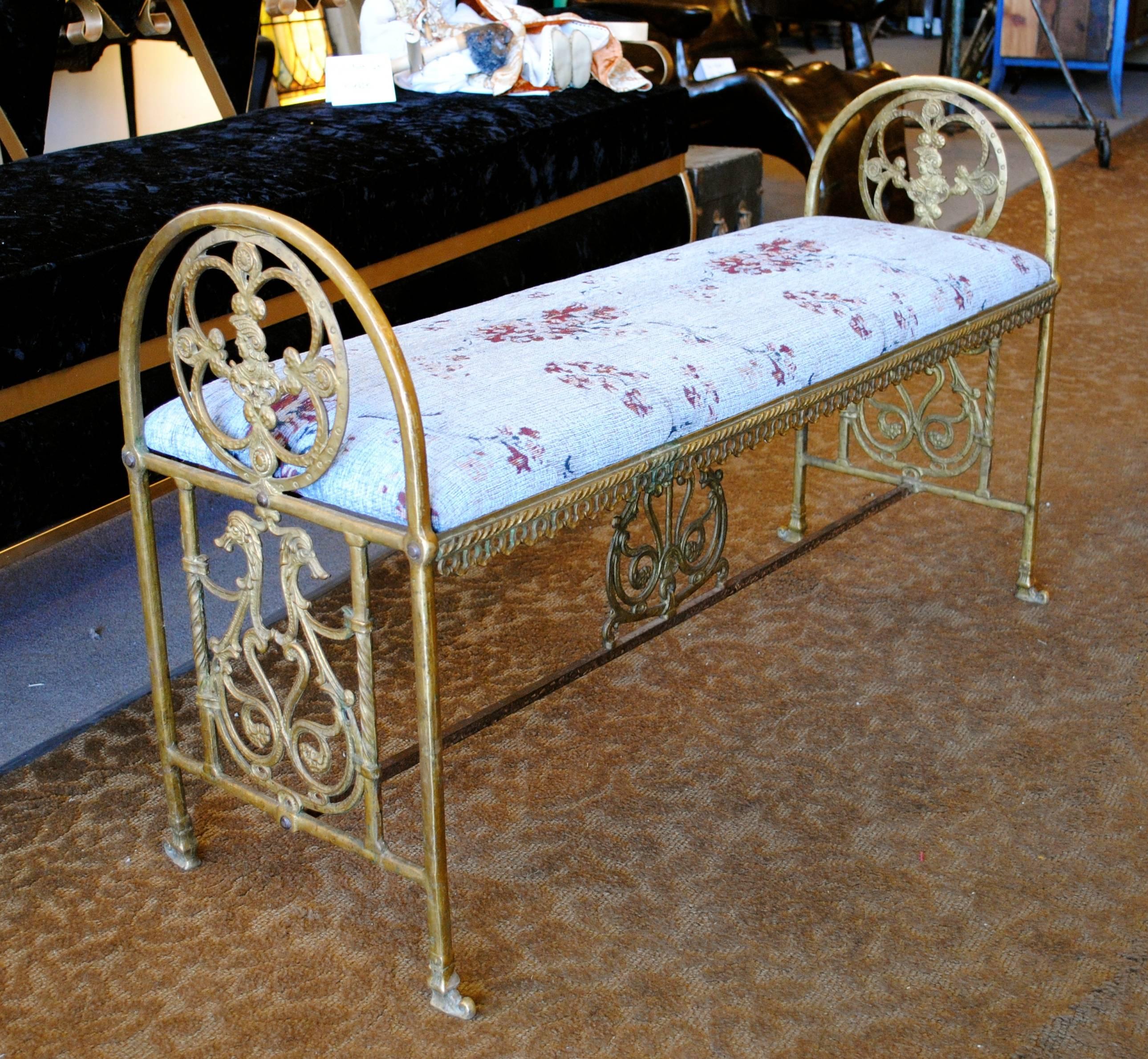 19th century brass bench in period upholstery.