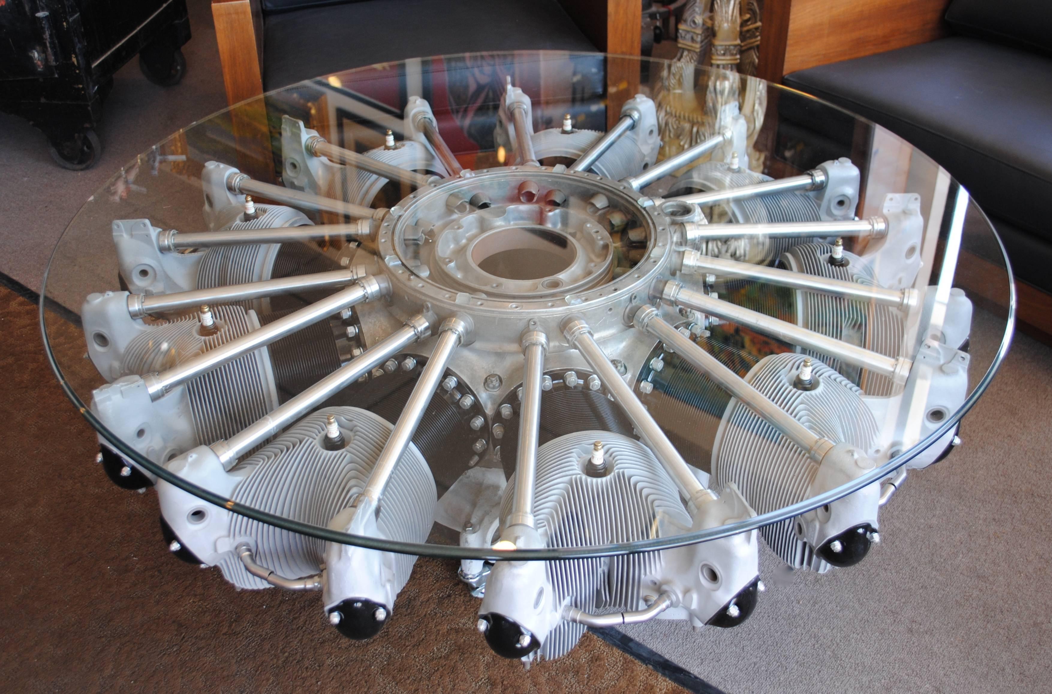 Nine cylinder radial aircraft engine coffee table. It has been beautifully finished and is topped with a 54