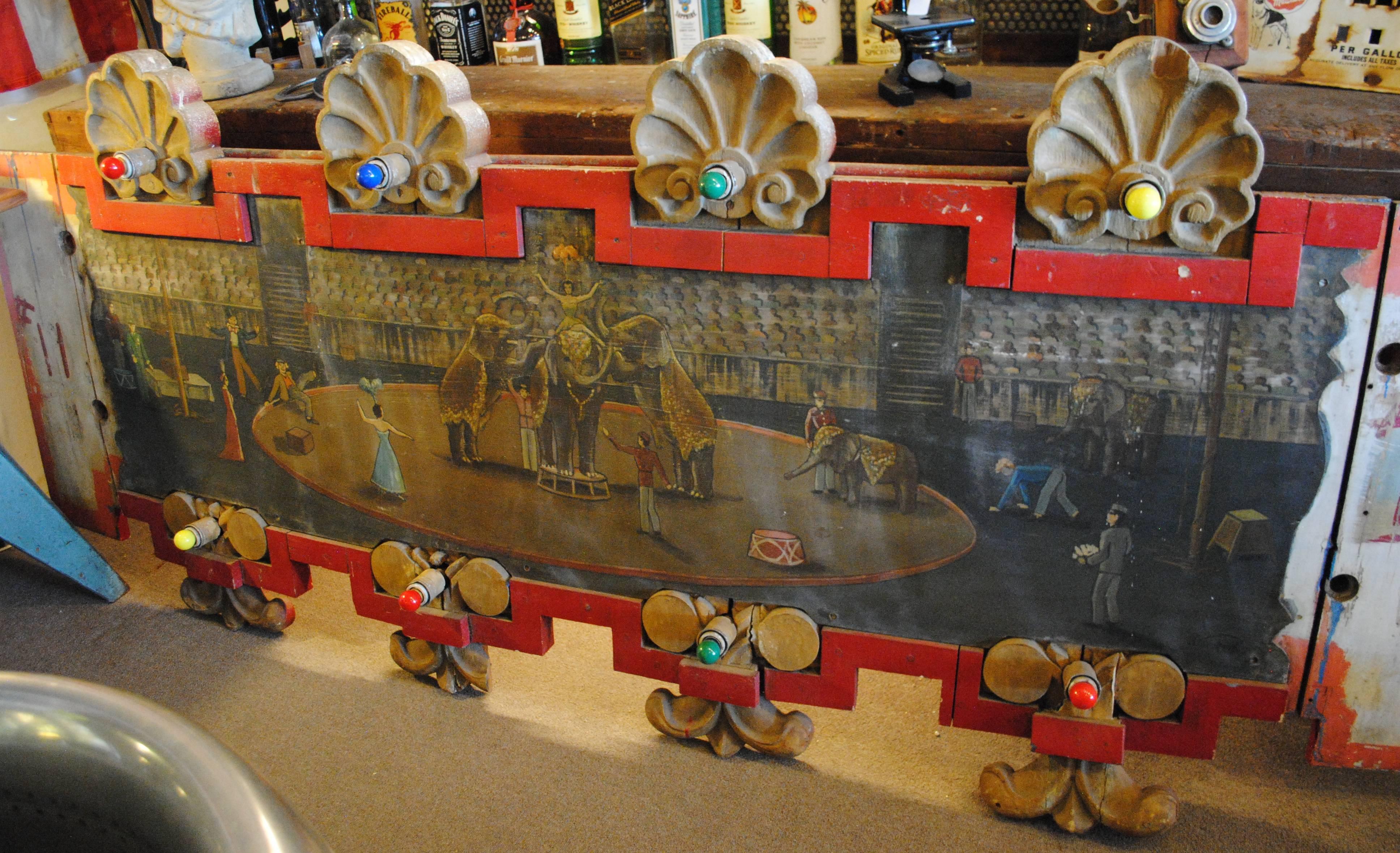 Folk Art painted wood carousel surround with working lights from Story Town Amusement Park, Lake George, NY. Painted by Peter Riley, noted Adirondack painter, circa 1954. Fantastic subject matter of the elephants act at the circus.
Dimensions 104