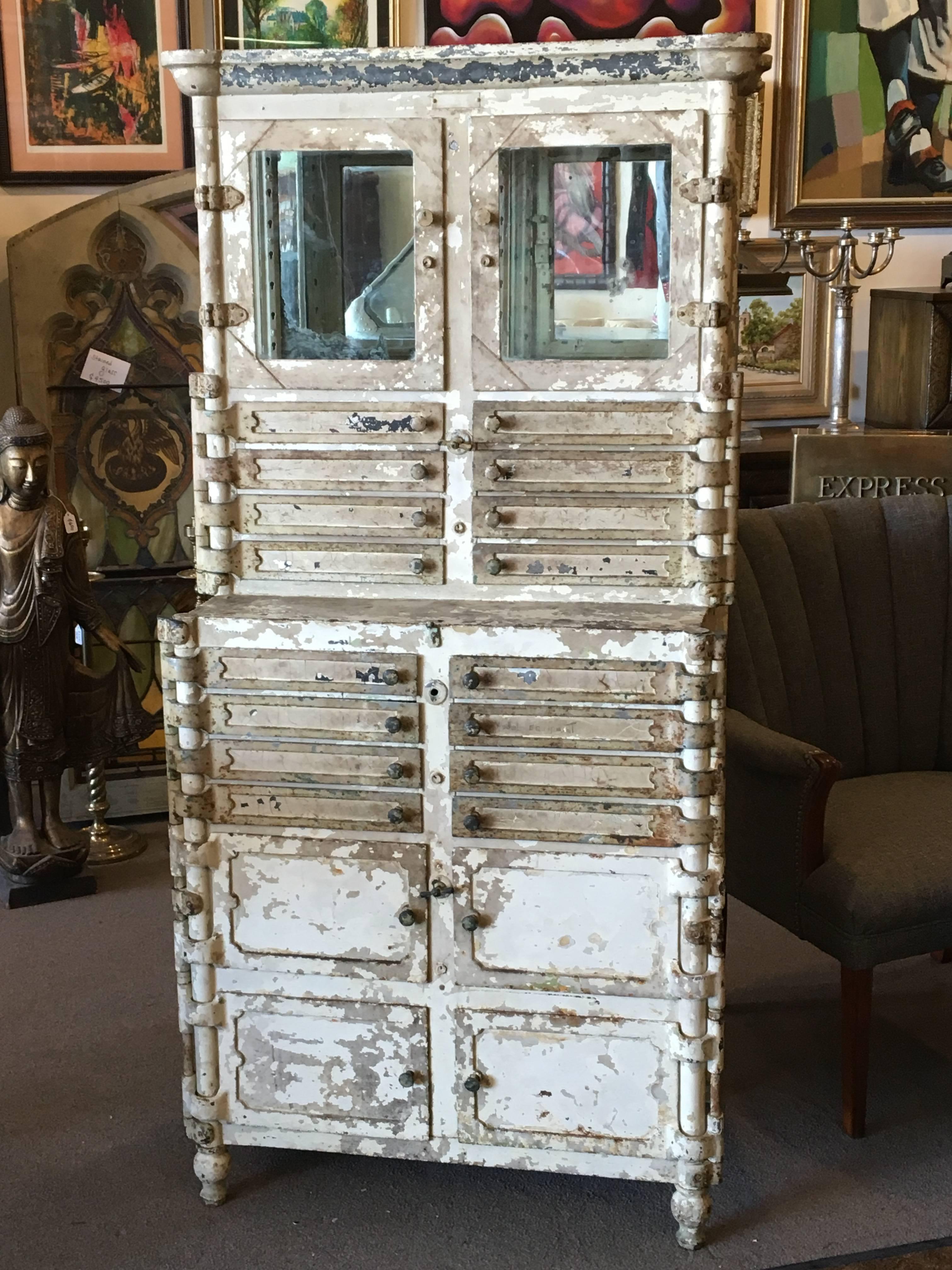 Extraordinary metal aseptic dental cabinet with all operable doors, drawers and original latches. This painted metal Lee S. Smith & Sons cabinet was made in Pittsburgh, Pennsylvania, circa 1920. In original condition with really fantastic patina.
