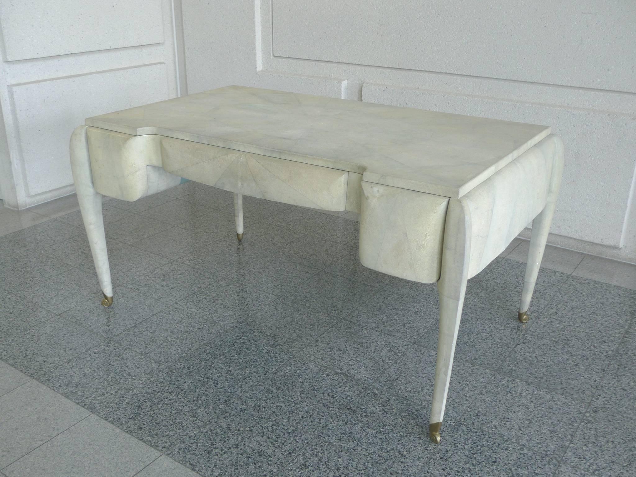 This outstanding Art Deco style desk is crafted by Maitland-Smith. The company is well known for its use of unusual materials such as fossil stone and shagreen. This desk is beautifully covered with the latter. The shagreen is arranged in a
