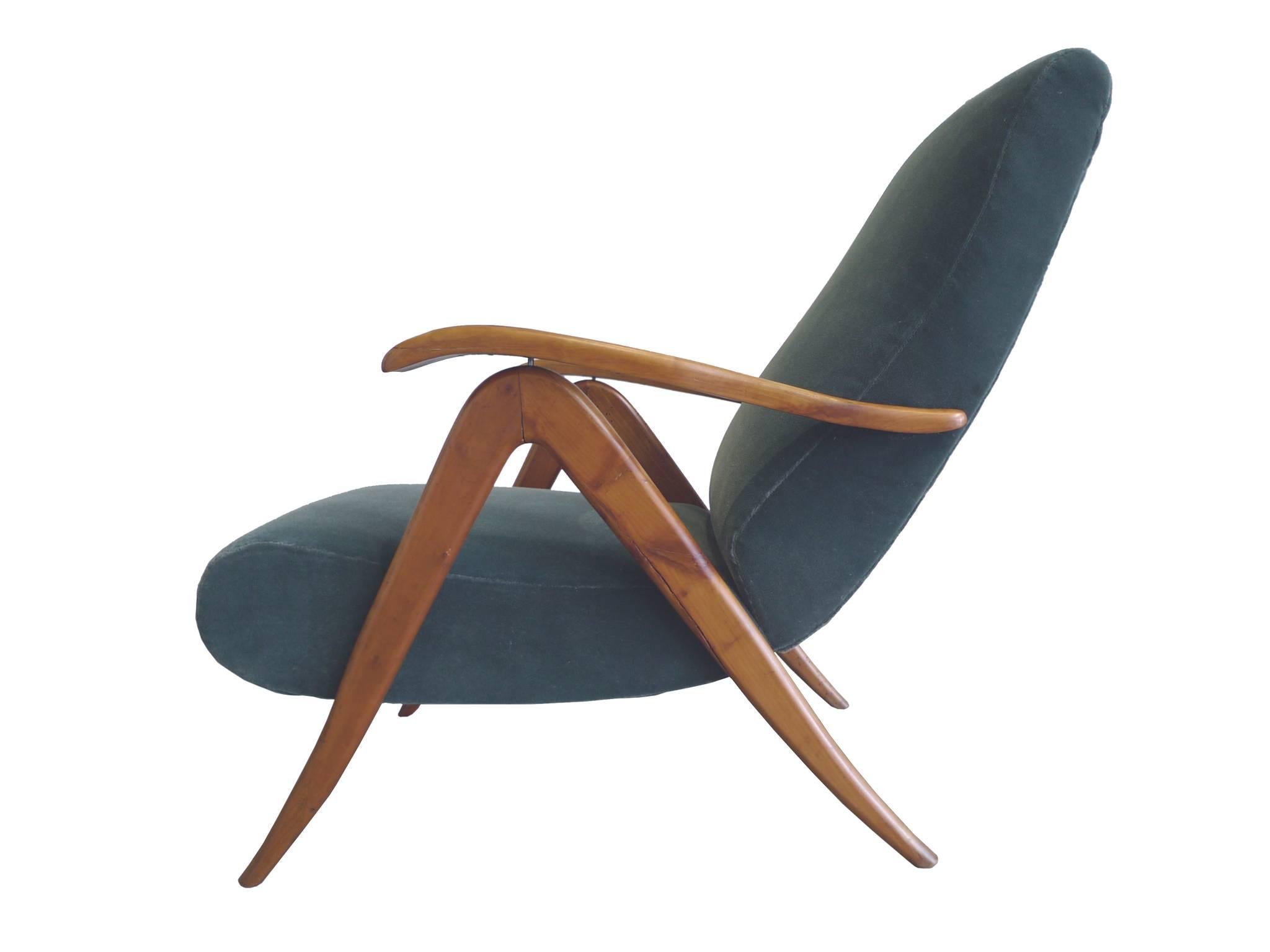 These 1940s reclining armchairs are in the style of Carlo Mollino. Similar to his furniture designs, these chairs make use of sensuous and evocative shapes. You can see these characteristics in the curves and carved quality of the arms and legs,