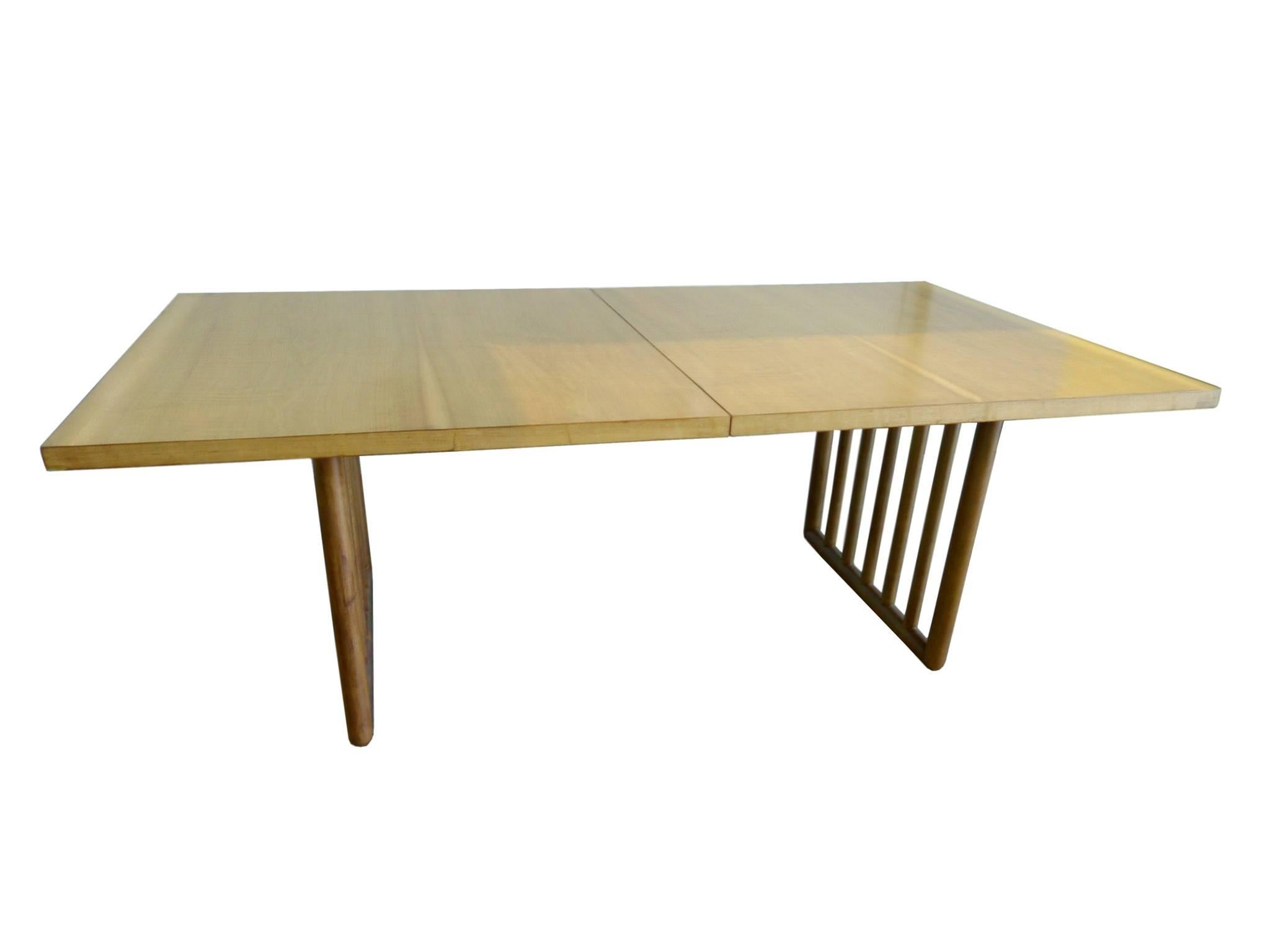 This mid-20th century Robsjohn-Gibbings dining table is beautifully crafted from mahogany. Robsjohn-Gibbings designs were influenced by his love of Classical Greek art; that is apparent in the table’s symmetry and minimalism. There's a sense of