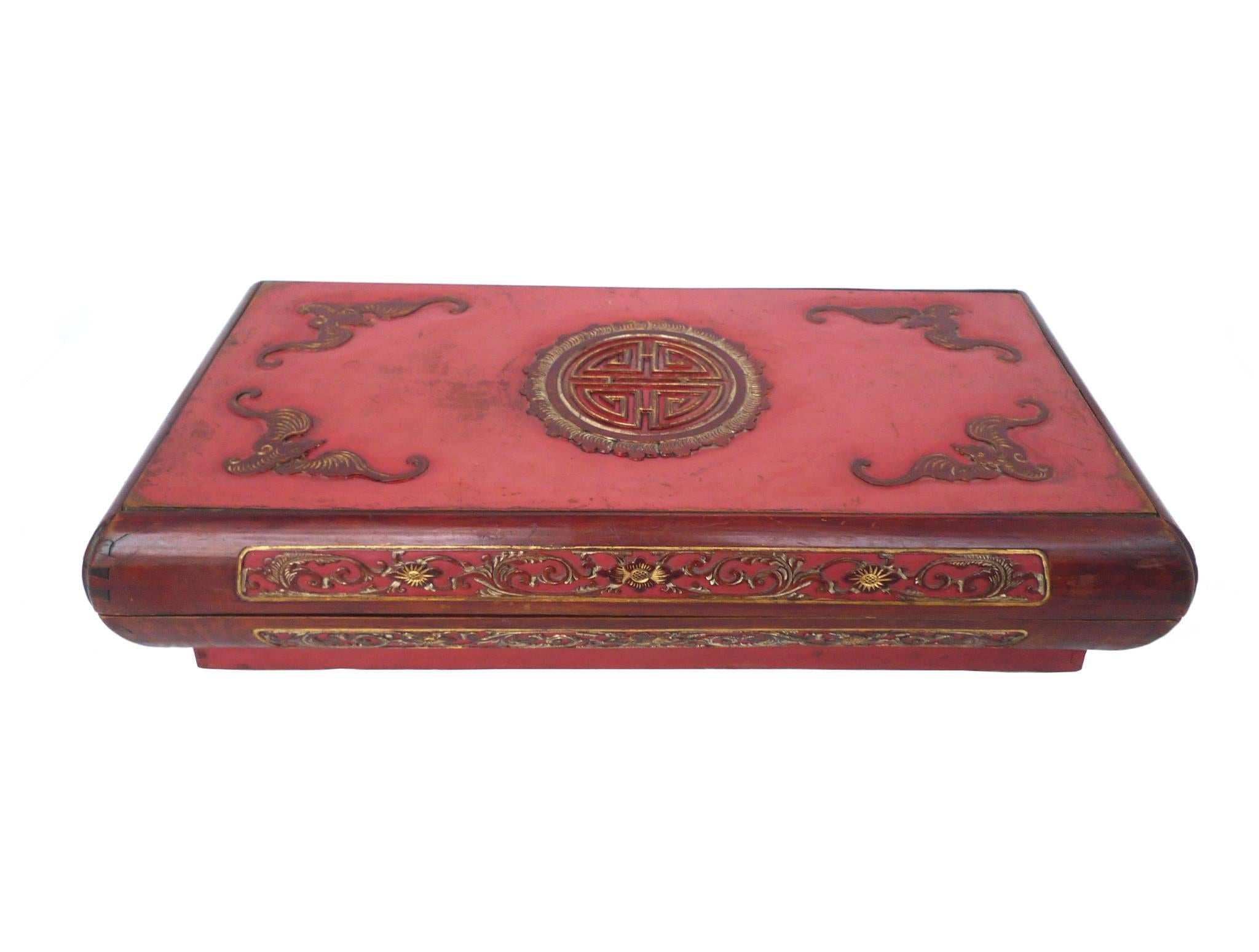 These Chinese scholar boxes were created in the early 20th century. Their palette is a rich spectrum of reds, varying in texture and finishes. The beautiful carved decorations include a floral frieze on the sides and four bats on atop each lid, with
