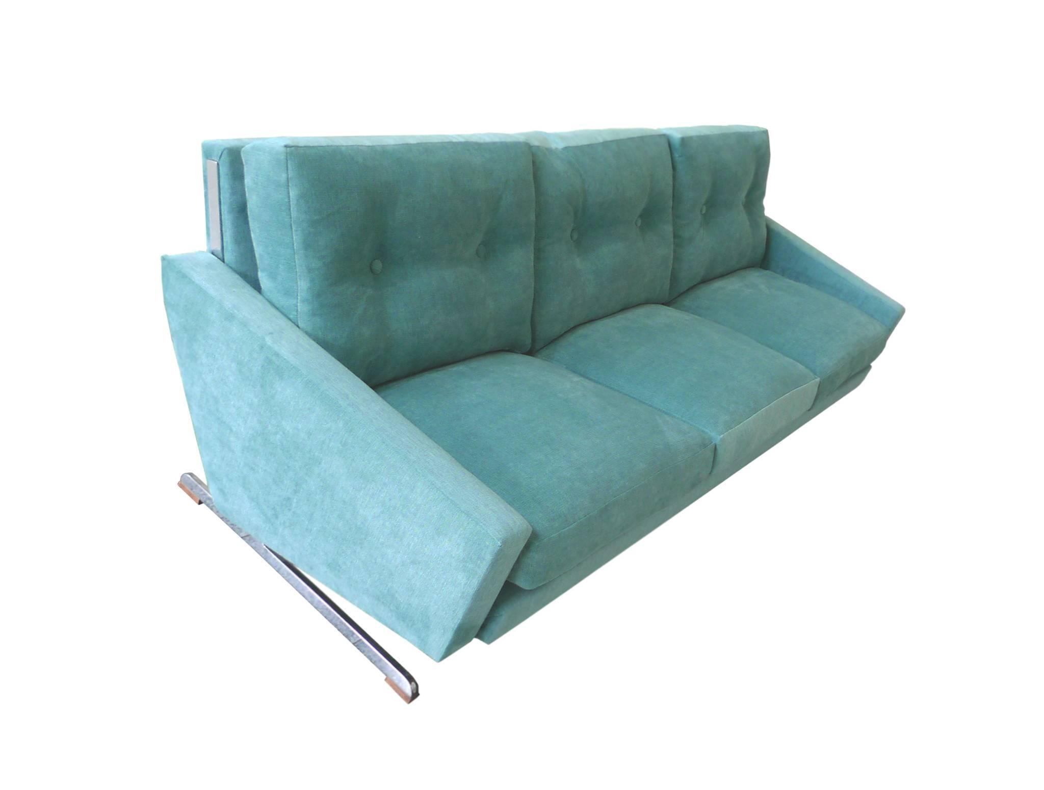 This Danish Midcentury sofa is by Johannes Andersen. His furniture are renowned for their soft, sculptural shapes - in combinations of teak, chrome and well padded upholstery. This sofa's dynamic design includes a slightly tilted back and