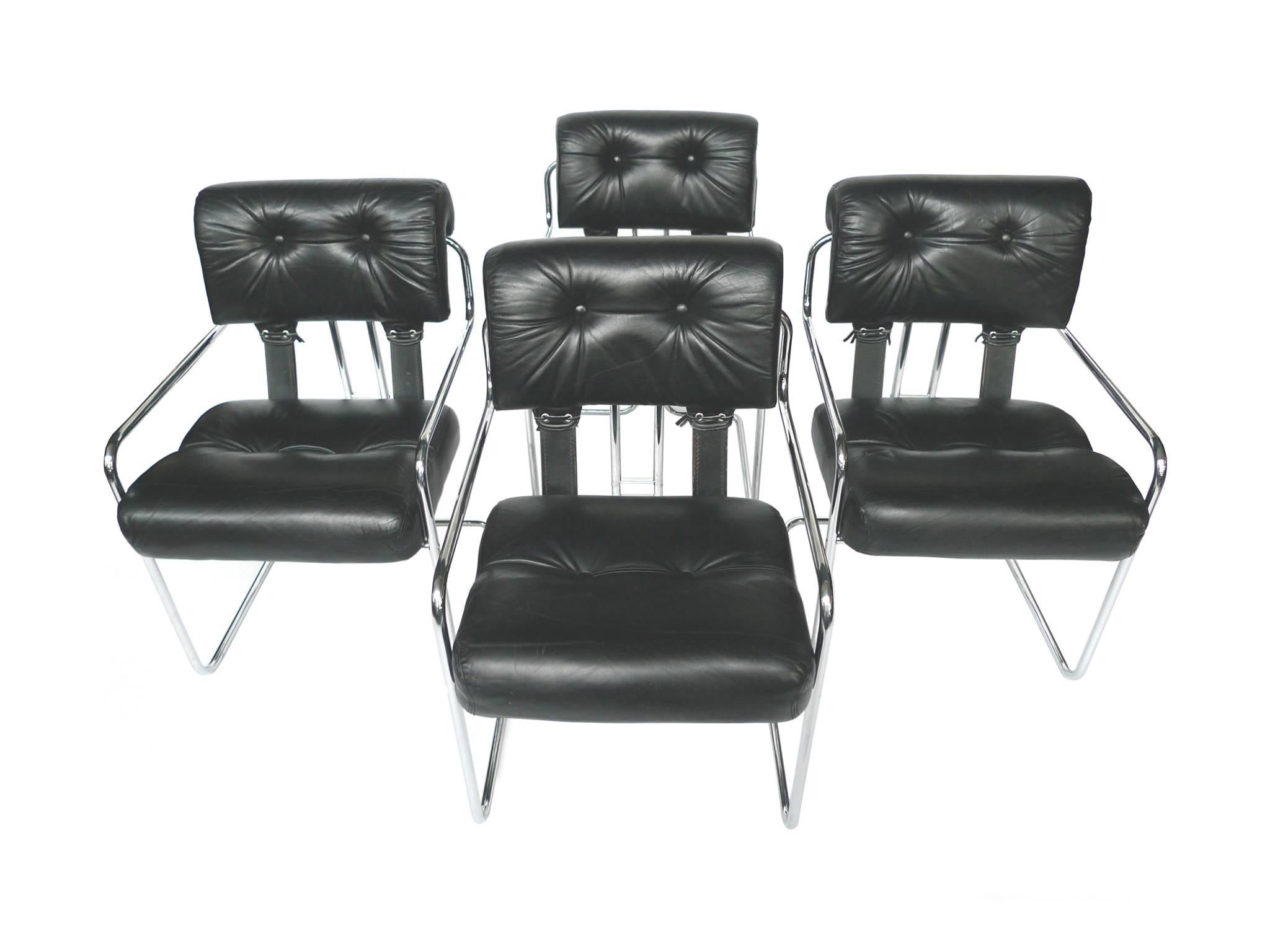 This set of four Italian dining chairs is designed by Guido Faleschini for the Pace collection. The chairs are upholstered in tufted, black leather, secured with leather straps at the back. The frame is tubular chrome. Faleschini's chairs are