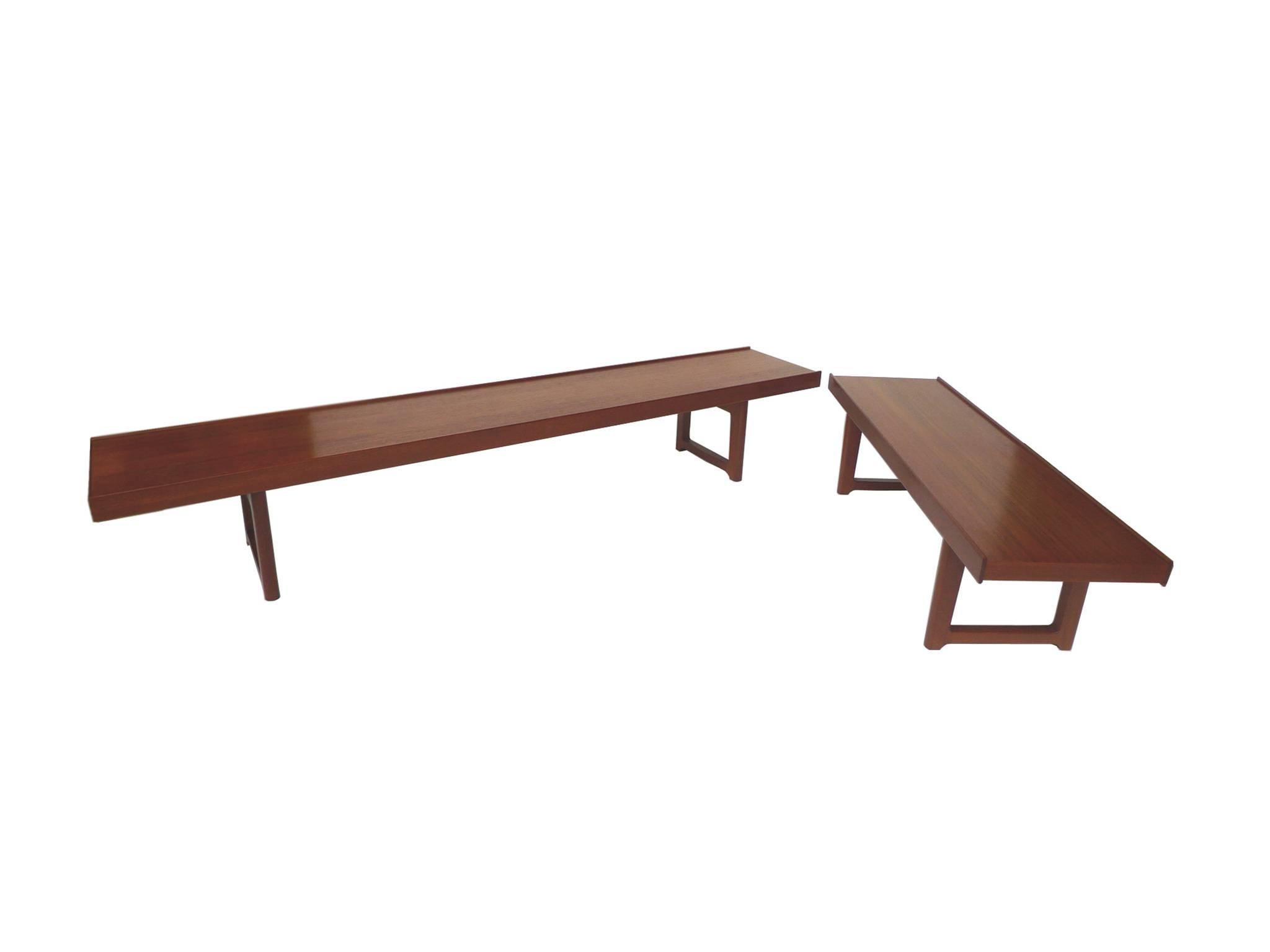 This versatile set of solid teak bench-tables was designed by Torbjørn Afdal for Bruksbo Norway in the 1960s. It consists of a long table-bench and a smaller one, with two original black leather pillows. The table-benches are designed with smooth