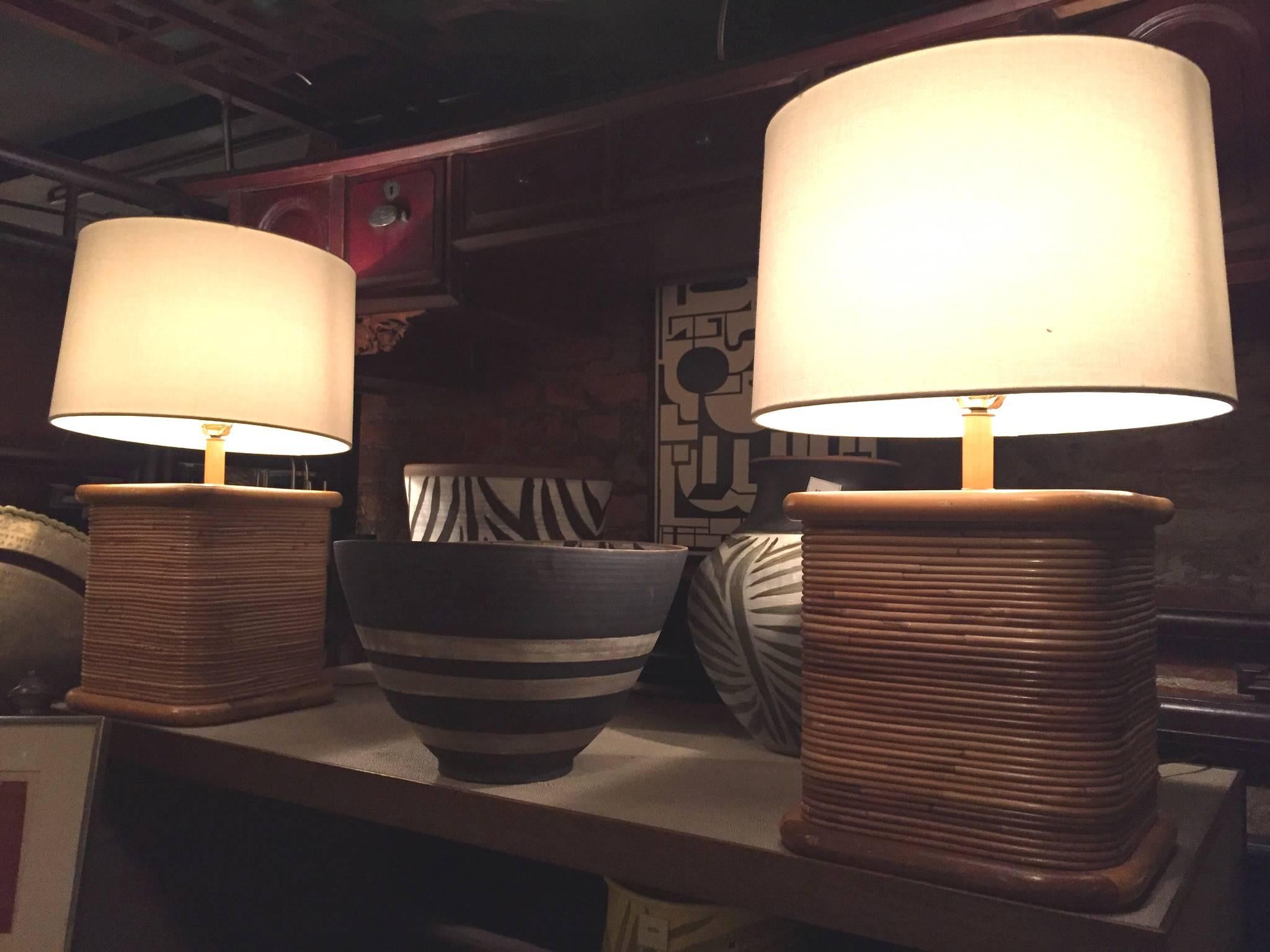These mid-20th century rattan cube lamps are in the eclectic style of designer Paul Frankl, who was renowned for his rattan furniture. Like those Frankl chairs and sofas, these lamps have an organic look with smooth lines and soft edges. The lamps