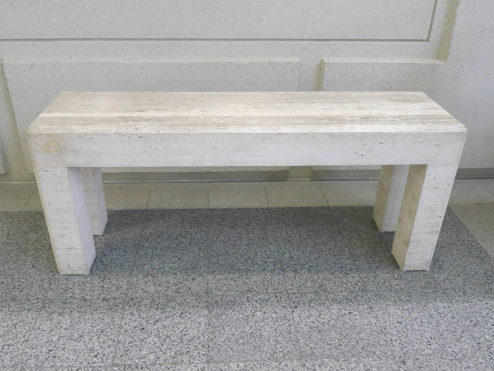 Because of its low height, this 20th Century travertine parsons console table can be utilized as a sofa table or as a tall coffee table. The table's design is minimal and makes great decorative use of the travertine's inherent properties. The pocked