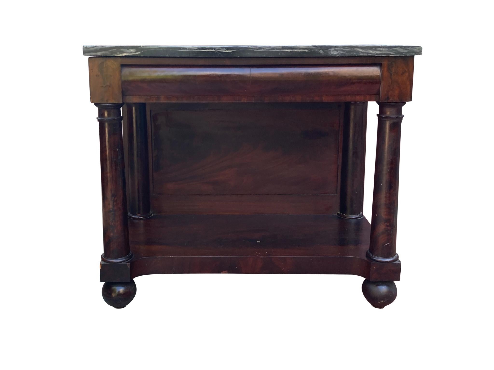 This American Federal pier table was handmade circa 1825. It is comprised of a mahogany base with mahogany veneer and marble top. Inspired by Classical forms, the table's design features column-shaped leg supports and turned feet. 

Overall